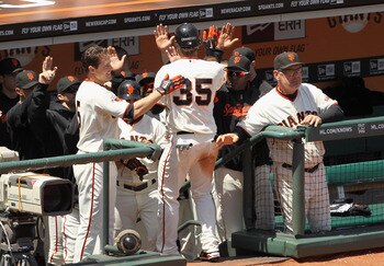 SAN FRANCISCO, CA - JUNE 08:  Brandon Crawford #35 of the San Francisco Giants is congratulated be teammates after he scored in the seventh inning against the Washington Nationals at AT&T Park on June 8, 2011 in San Francisco, California.  (Photo by Ezra
