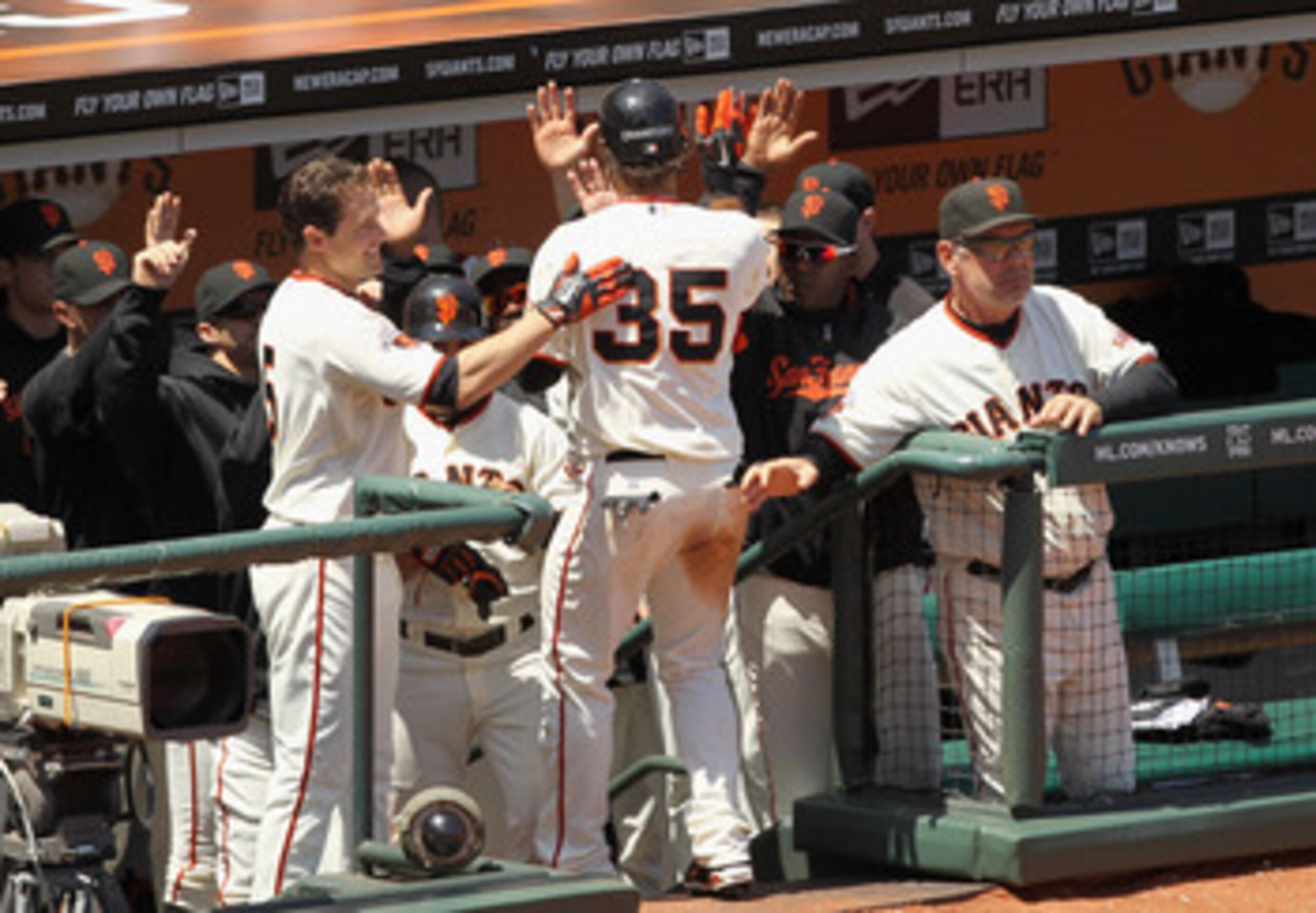 SAN FRANCISCO, CA - JUNE 08:  Brandon Crawford #35 of the San Francisco Giants is congratulated be teammates after he scored in the seventh inning against the Washington Nationals at AT&T Park on June 8, 2011 in San Francisco, California.  (Photo by Ezra
