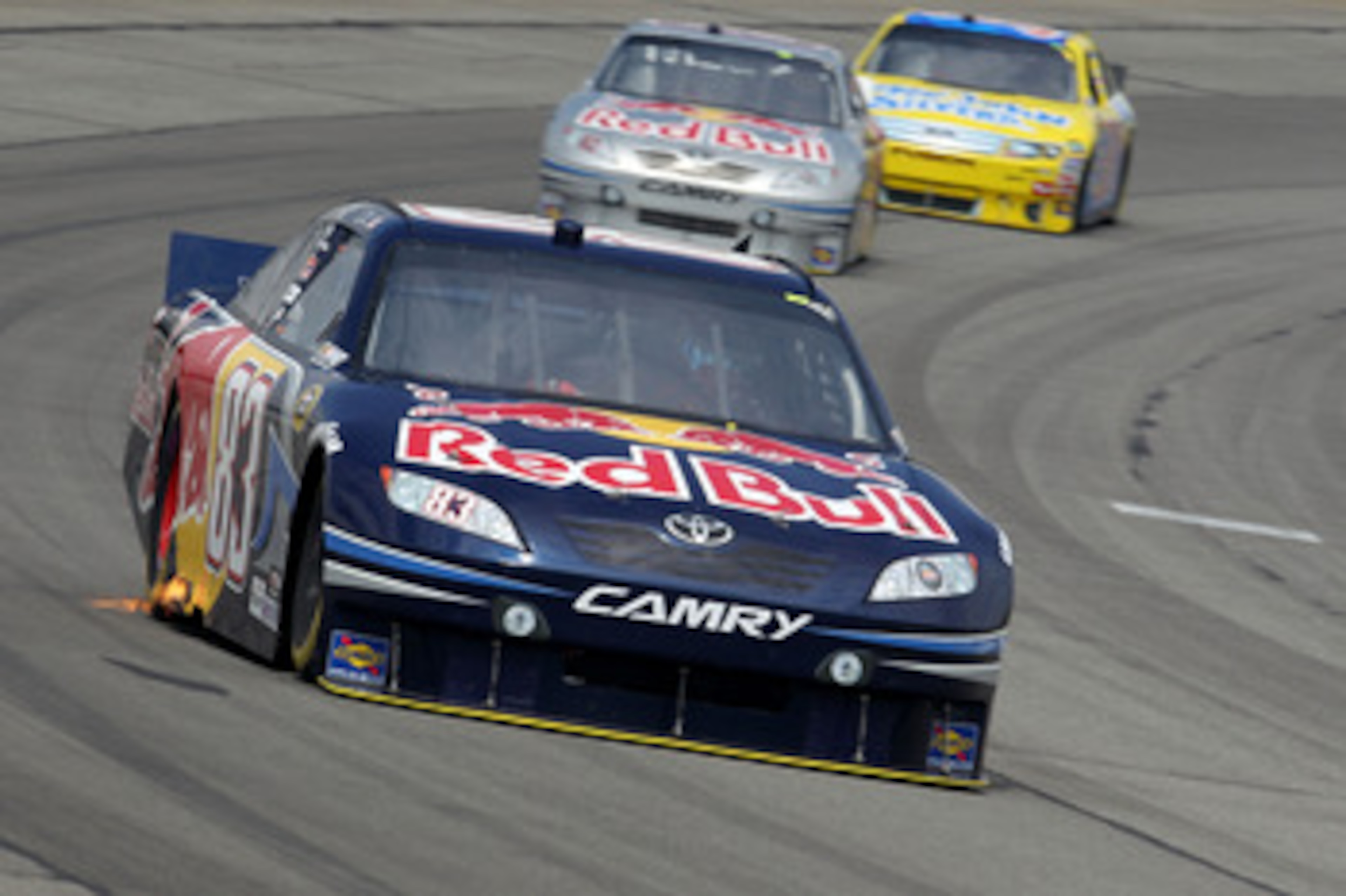 LONG POND, PA - AUGUST 01:  Reed Sorenson, driver of the #83 Red Bull Toyota, leads Scott Speed, driver of the #82 Red Bull Toyota, and Travis Kvapil, driver of the #38 Long John Silver's Ford,  during the NASCAR Sprint Cup Series Sunoco Red Cross Pennsyl