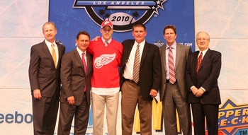 LOS ANGELES, CA - JUNE 25:  Riley Sheahan, drafted 21th overall by the Detroit Red Wings, poses on stage with team personnel during the 2010 NHL Entry Draft at Staples Center on June 25, 2010 in Los Angeles, California.  (Photo by Bruce Bennett/Getty Imag