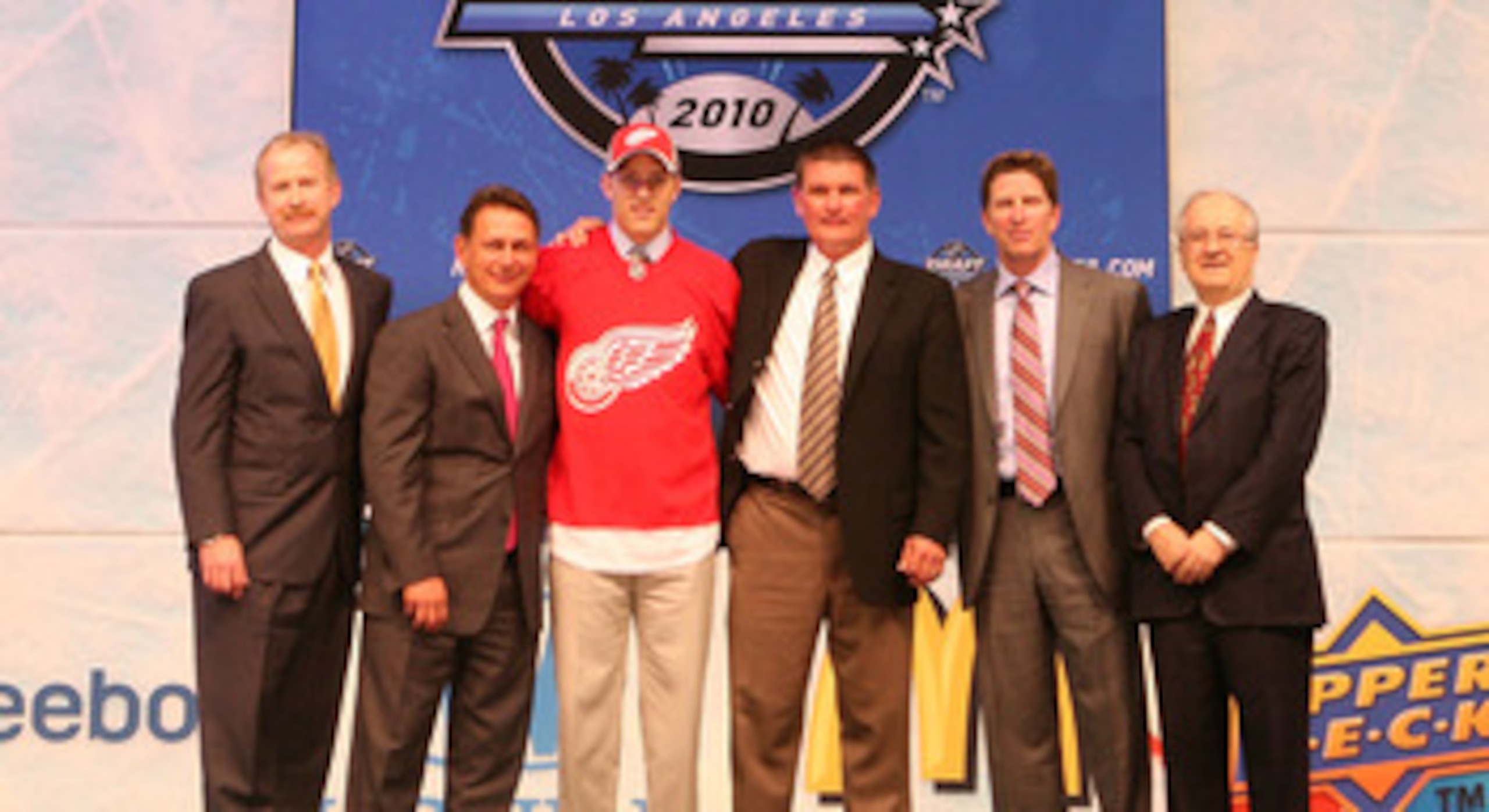 LOS ANGELES, CA - JUNE 25:  Riley Sheahan, drafted 21th overall by the Detroit Red Wings, poses on stage with team personnel during the 2010 NHL Entry Draft at Staples Center on June 25, 2010 in Los Angeles, California.  (Photo by Bruce Bennett/Getty Imag