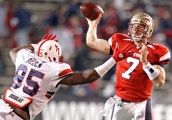 MOBILE, AL - JANUARY 29: Quarterback  Christian Ponder #7 of the South Team passes over defensive lineman Pierre Allen #95 North Team during the fourth quarter of the Under Armour Senior Bowl on January 29, 2011 at Ladd-Pebbles Stadium in Mobile, Alabama.