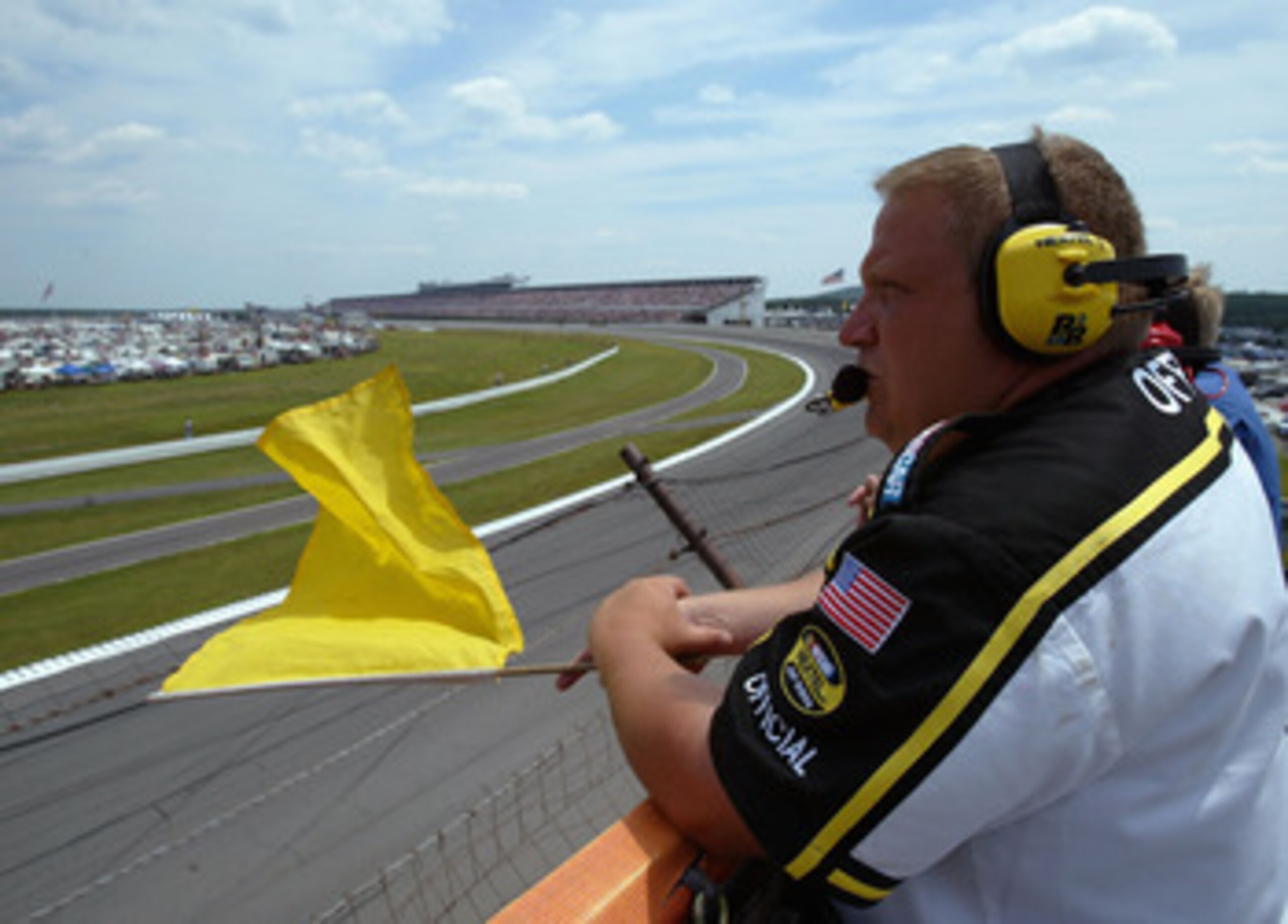 LONG PONG, PA - JULY 24:  A NASCAR official holds out the yellow flag for a caution during the NASCAR Nextel Cup Pennsylvania 500 on July 24, 2005 at the Pocono Raceway in Long Pond, Pennsylvania.  (Photo by Doug Pensinger/Getty Images)