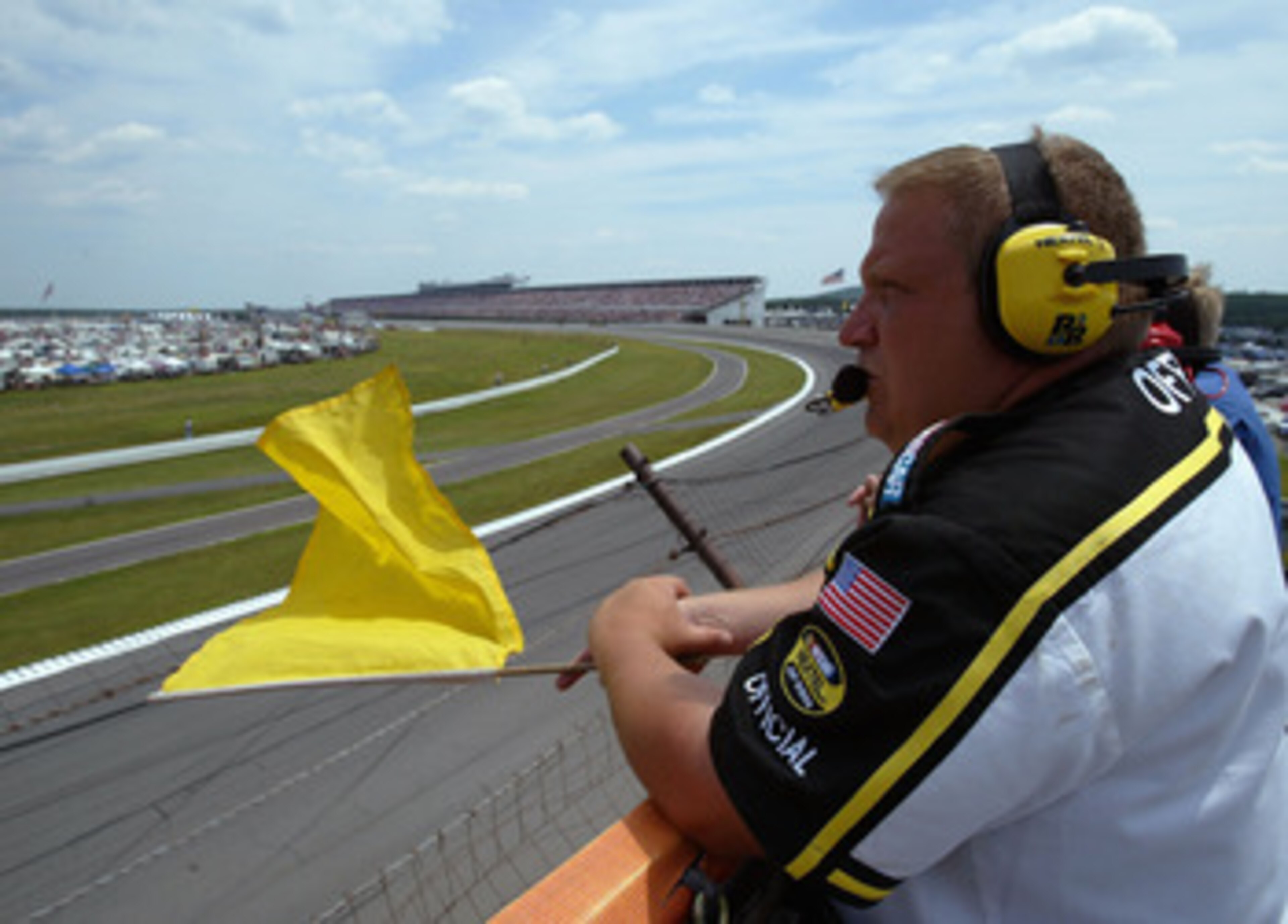 LONG PONG, PA - JULY 24:  A NASCAR official holds out the yellow flag for a caution during the NASCAR Nextel Cup Pennsylvania 500 on July 24, 2005 at the Pocono Raceway in Long Pond, Pennsylvania.  (Photo by Doug Pensinger/Getty Images)
