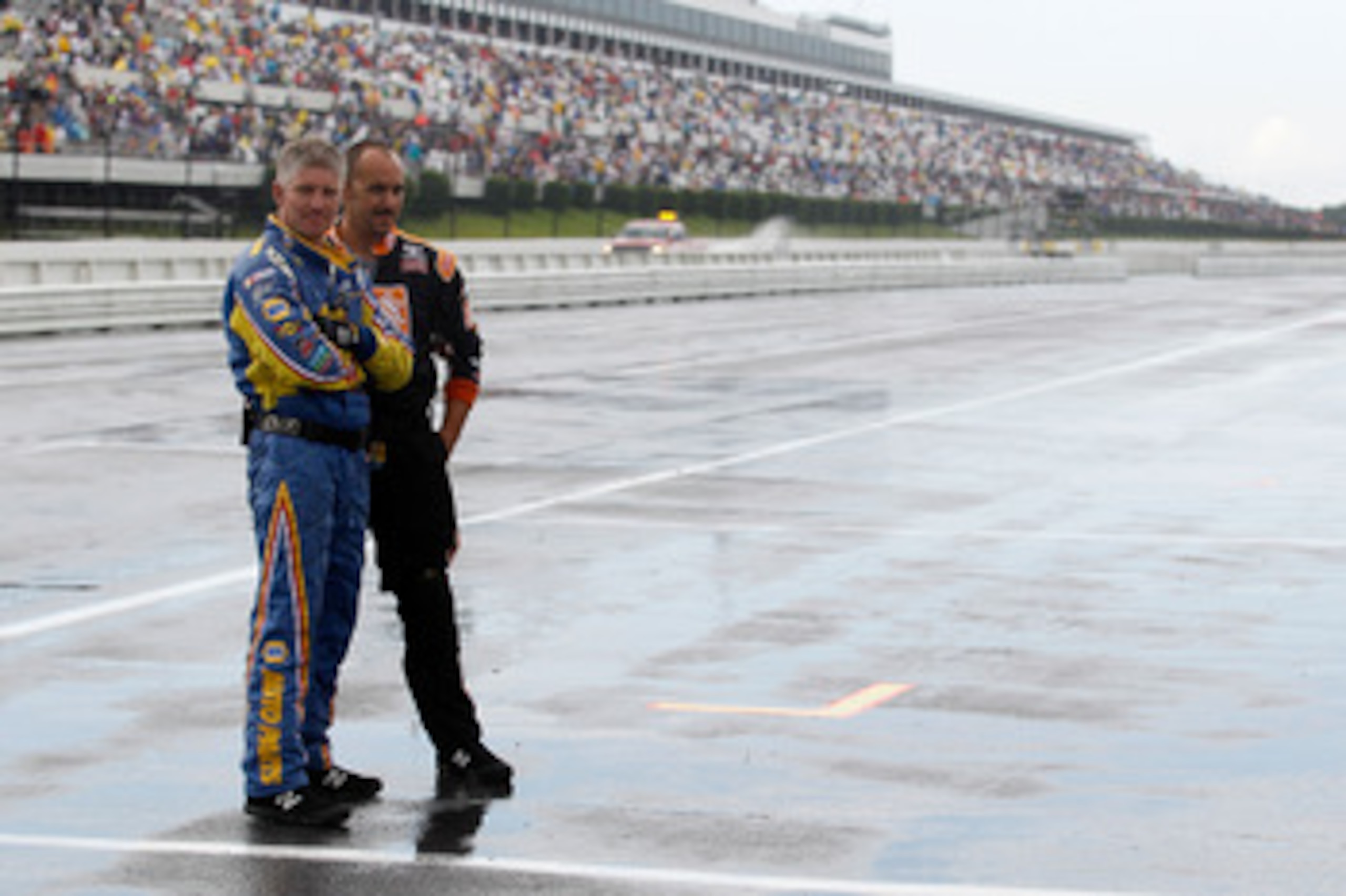 LONG POND, PA - JUNE 06:  Crew members stand on pit road during a rain caution in the NASCAR Sprint Cup Series Gillette Fusion ProGlide 500 at Pocono Raceway on June 6, 2010 in Long Pond, Pennsylvania.  (Photo by Todd Warshaw/Getty Images)
