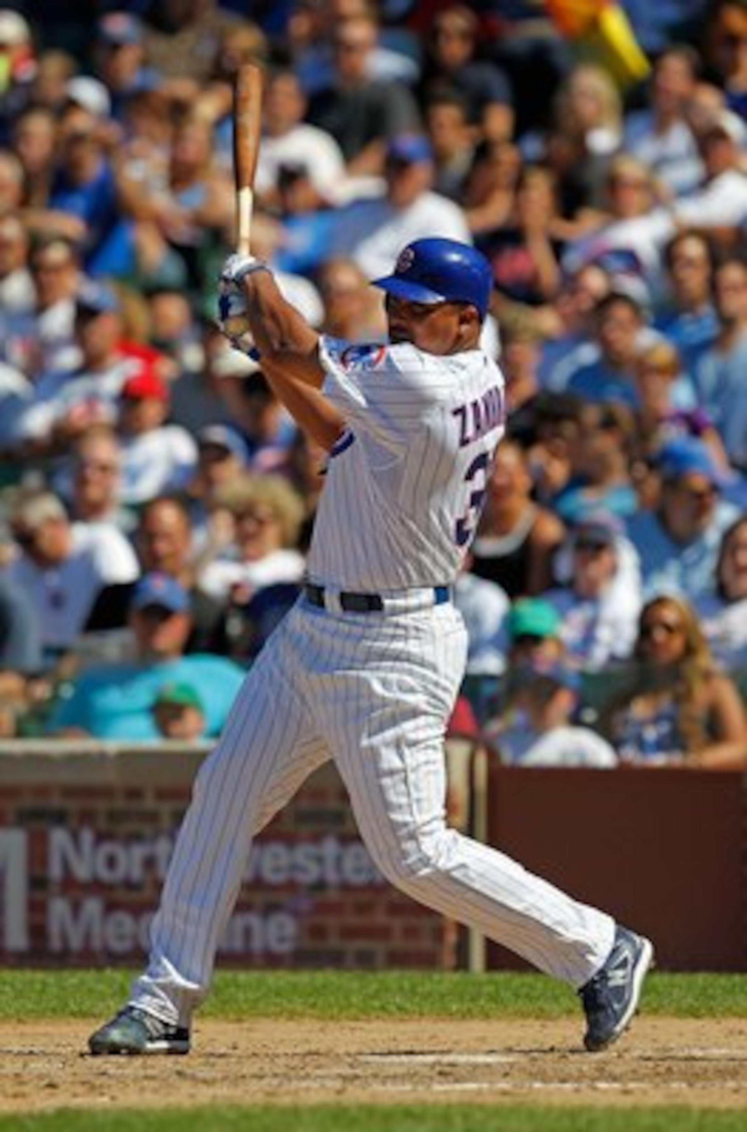 CHICAGO - JUNE 20: Carlos Zambrano #38 of the Chicago Cubs hits a single in the 7th inning against the Los Angeles Angels of Anaheim at Wrigley Field on June 20, 2010 in Chicago, Illinois. The Cubs defeated the Angels 12-1. (Photo by Jonathan Daniel/Getty