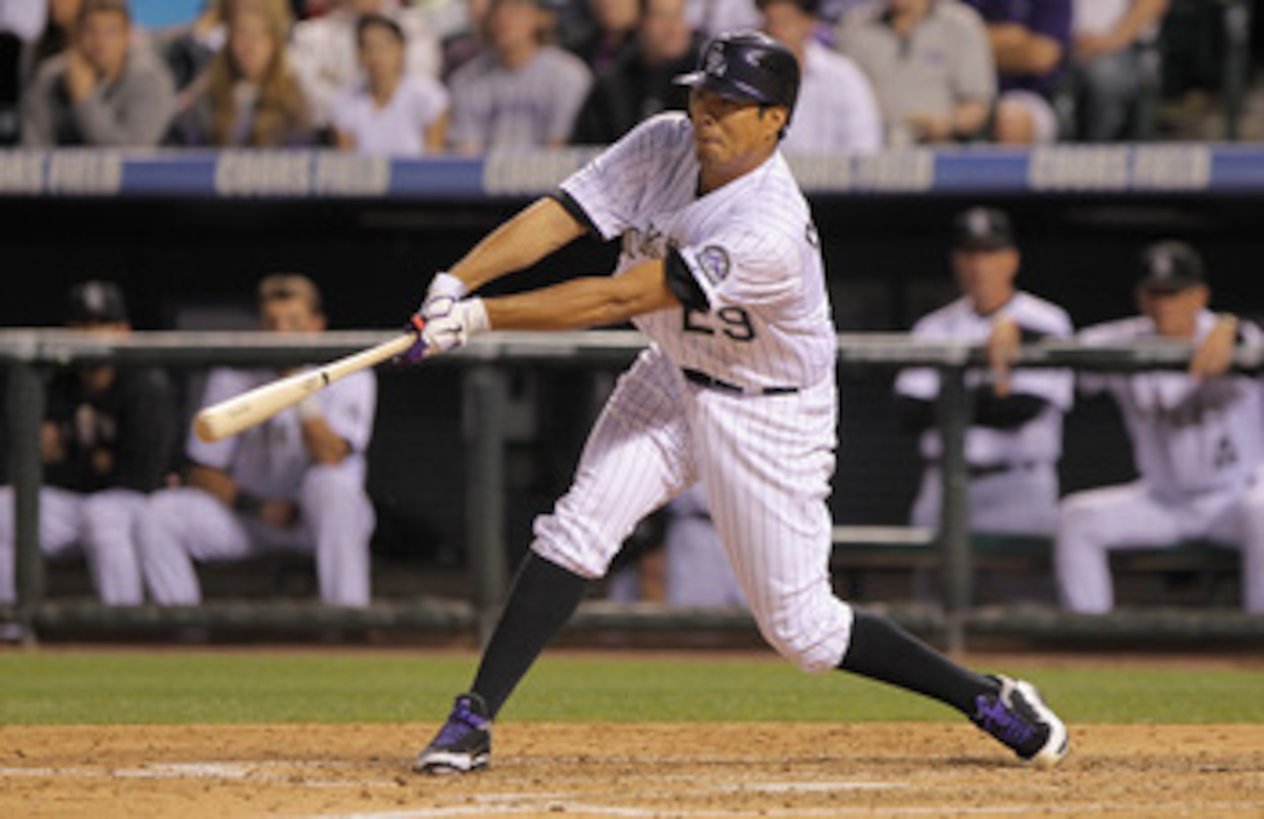 DENVER, CO - APRIL 02:  Starting pitcher Jorge De La Rosa #29 of the Colorado Rockies follows through on an RBI single that scored Chris Iannetta to give the Rockies a 3-0 lead over the Arizona Diamondbacks in the fourth inning at Coors Field on April 2, 