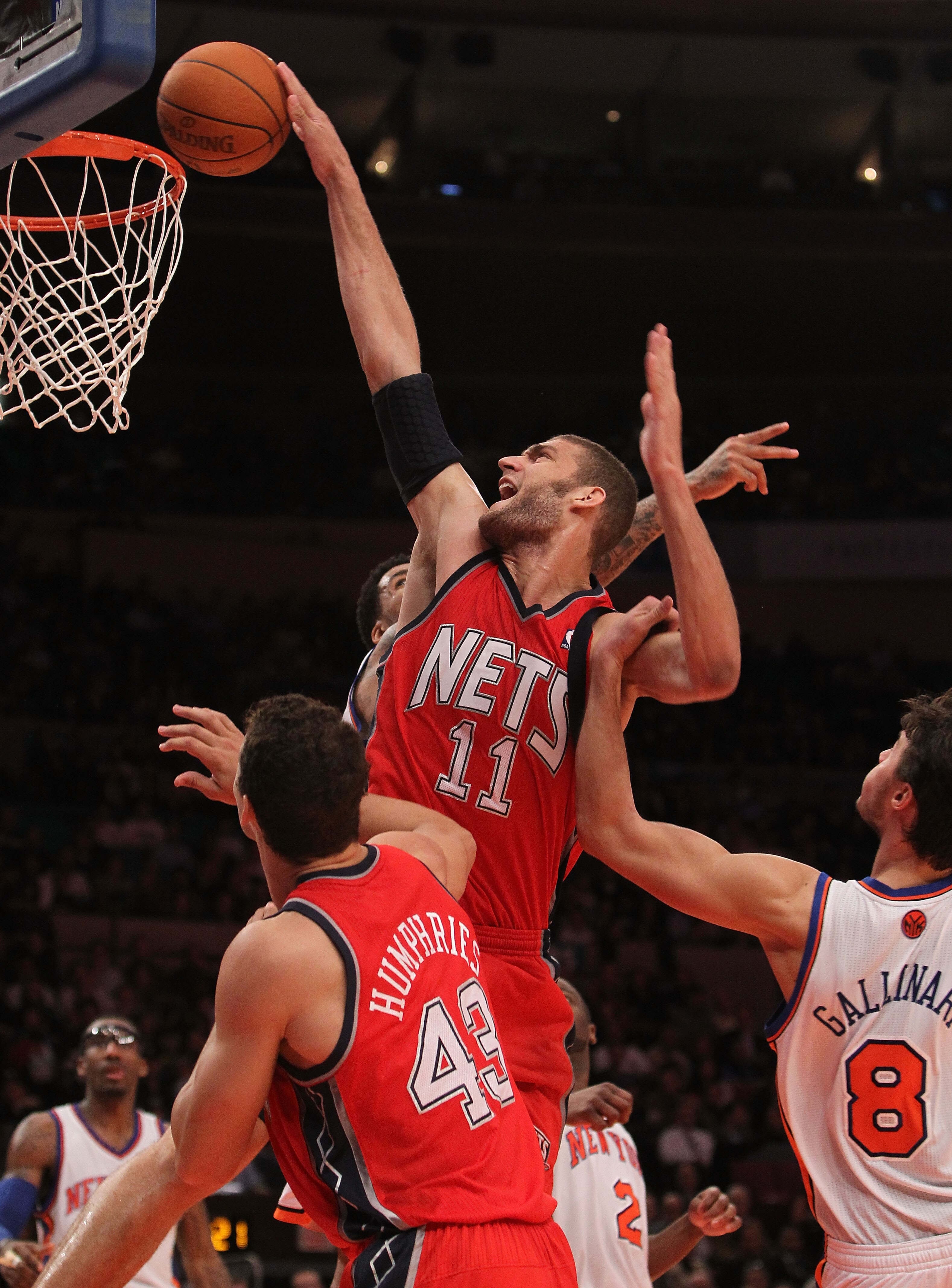 NEW YORK, NY - NOVEMBER 30: Brook Lopez #11 of the of the New Jersey Nets is fouled by Danilo Gallinari #8 of the New York Knicks on November 30, 2010 at Madison Square Garden in New York City. NOTE TO USER: User expressly acknowledges and agrees that, by