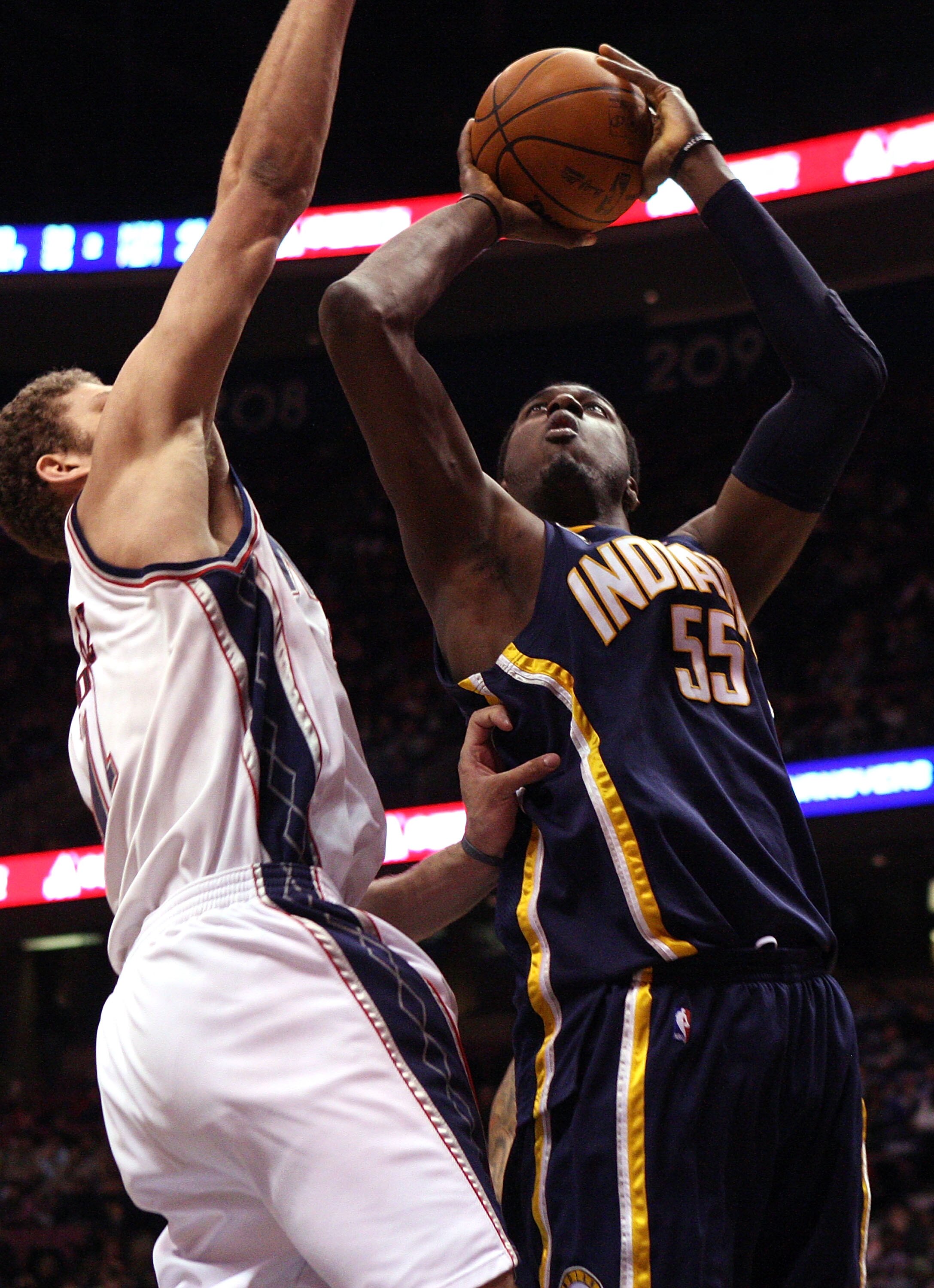 EAST RUTHERFORD, NJ - JANUARY 15:  Roy Hibbert #55 of the Indiana Pacers shoots against Brook Lopez #11 of the New Jersey Nets at the Izod Center on January 15, 2010 in East Rutherford, New Jersey. NOTE TO USER: User expressly acknowledges and agrees that