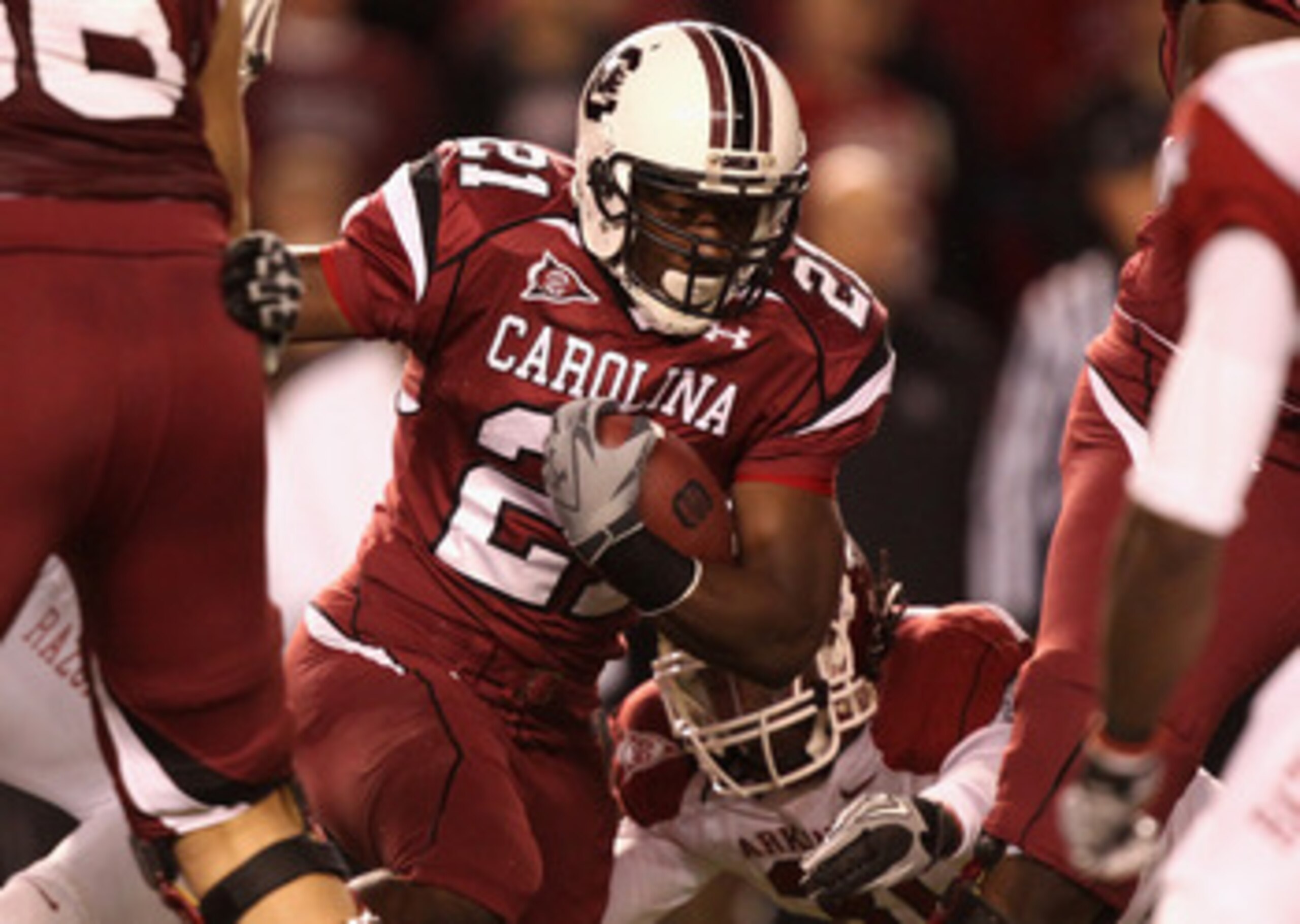 COLUMBIA, SC - NOVEMBER 06:  Jerico Nelson #31 of the Arkansas Razorbacks tries to stop Marcus Lattimore #21 of the South Carolina Gamecocks during their game at Williams-Brice Stadium on November 6, 2010 in Columbia, South Carolina.  (Photo by Streeter L