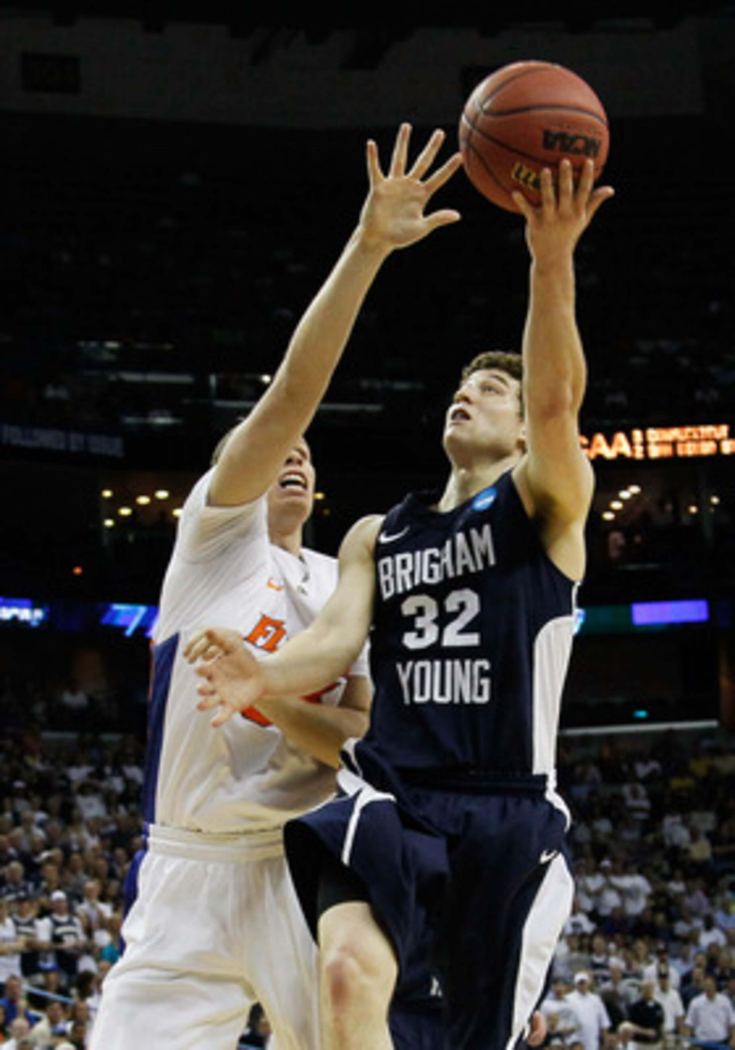 NEW ORLEANS, LA - MARCH 24:  Jimmer Fredette #32 of the Brigham Young Cougars shoots over Erik Murphy #33 of the Florida Gators during the Southeast regional of the 2011 NCAA men's basketball tournament at New Orleans Arena on March 24, 2011 in New Orlean