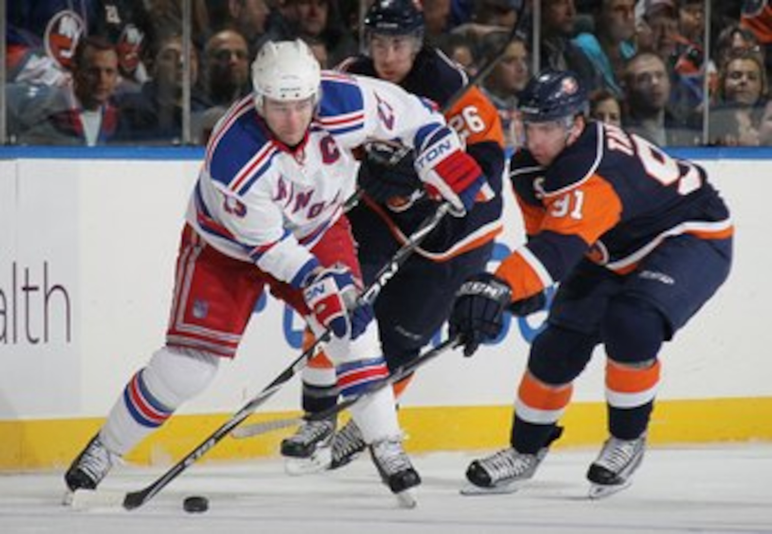 UNIONDALE, NY - MARCH 30:  Chris Drury #23 of the New York Rangers skates against John Tavares #91 of the New York Islanders at the Nassau Coliseum on March 30, 2010 in Uniondale, New York.  (Photo by Bruce Bennett/Getty Images)