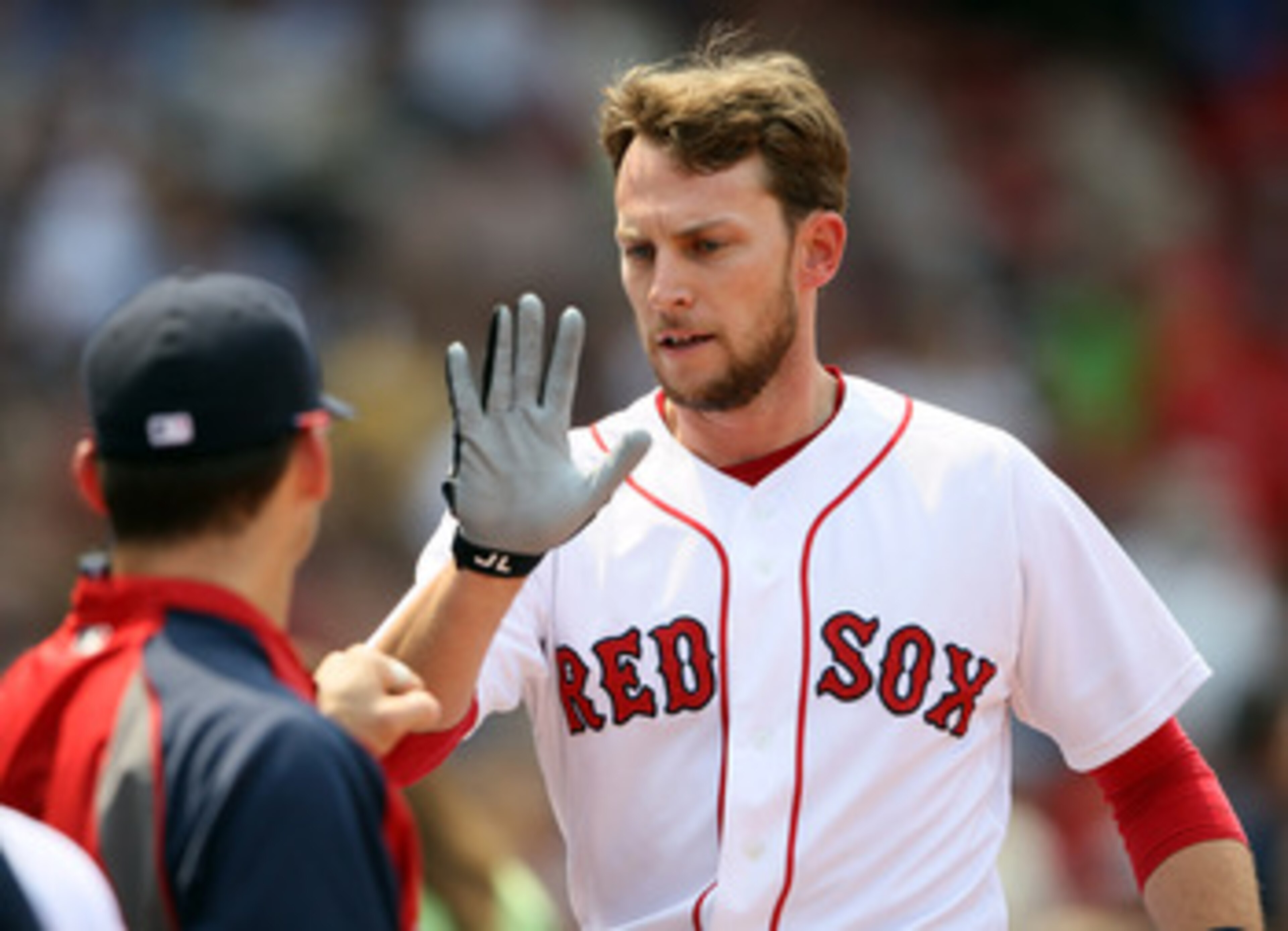 BOSTON, MA - JUNE 01:  Jed Lowrie #12 of the Boston Red Sox is congratulated after he scored in the second inning against the Chicago White Sox on June 1, 2011 at Fenway Park in Boston, Massachusetts.  (Photo by Elsa/Getty Images)