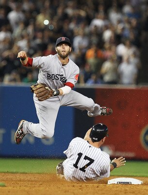 NEW YORK, NY - JUNE 08:  Dustin Pedroia #15 of the Boston Red Sox turns a double play as Francisco Cervelli #17 of the New York Yankees slides into second base during their game on June 8, 2011 at Yankee Stadium in the Bronx borough of New York City.  (Ph
