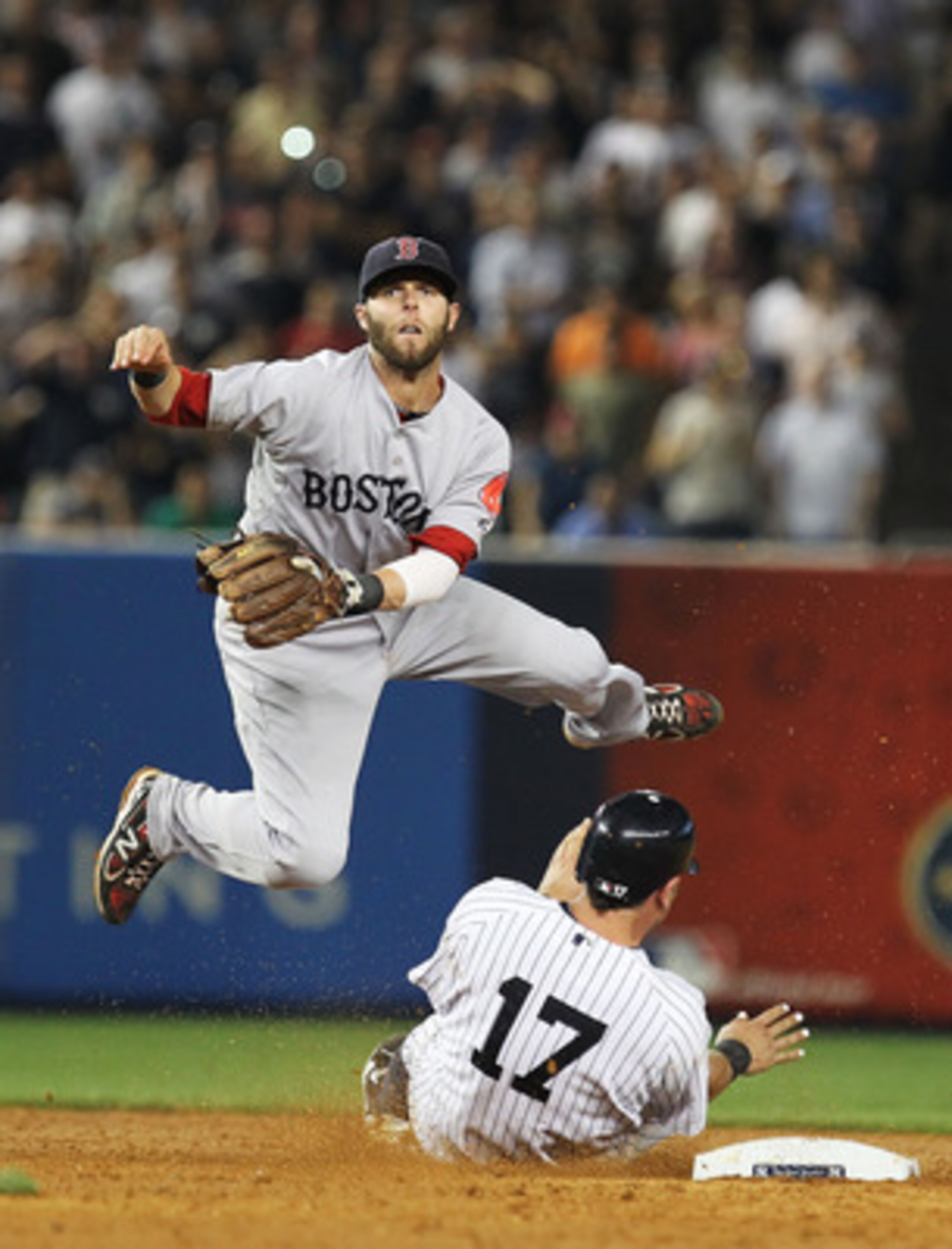 NEW YORK, NY - JUNE 08:  Dustin Pedroia #15 of the Boston Red Sox turns a double play as Francisco Cervelli #17 of the New York Yankees slides into second base during their game on June 8, 2011 at Yankee Stadium in the Bronx borough of New York City.  (Ph