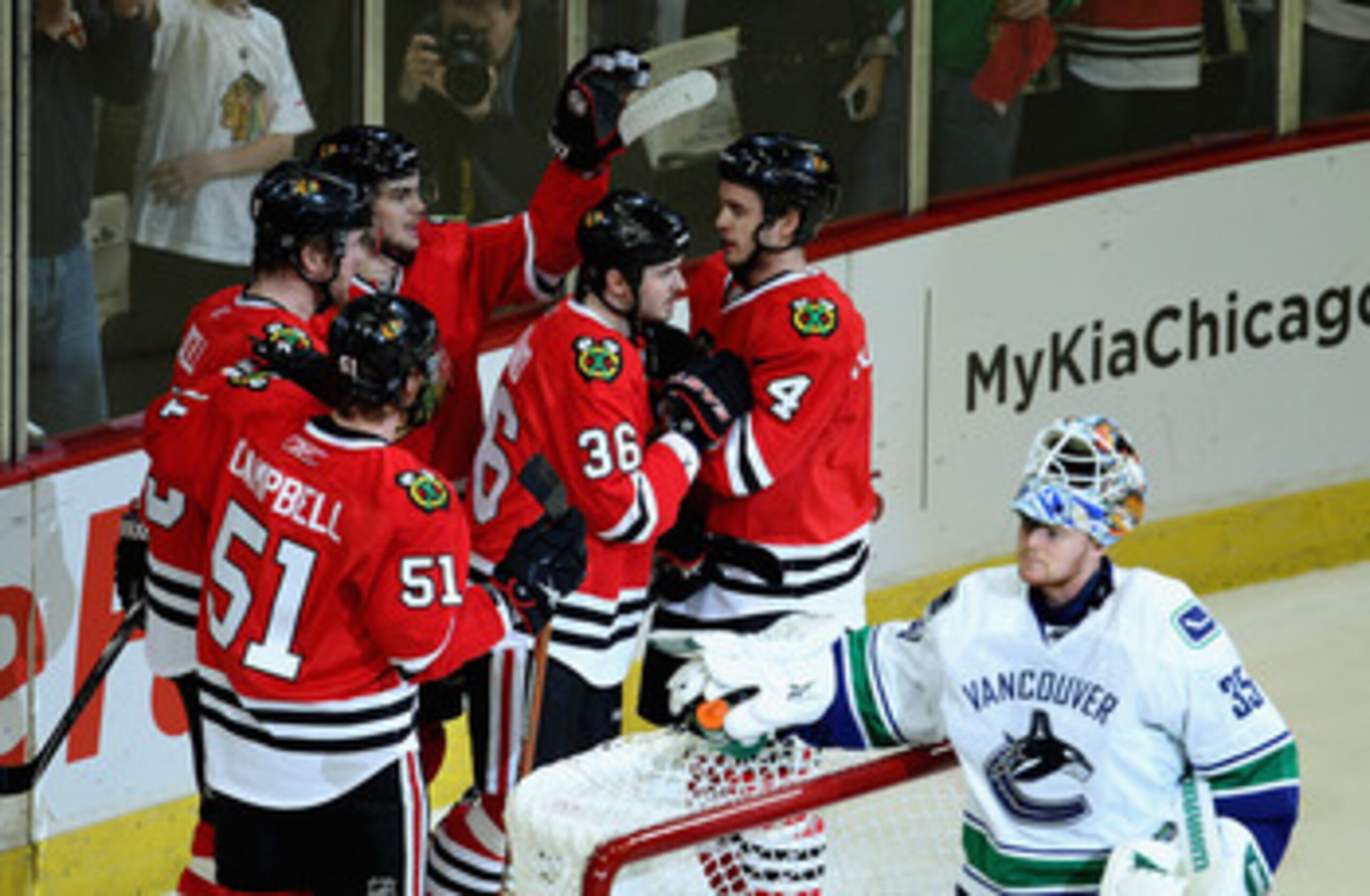 CHICAGO, IL - APRIL 24: (L-R) Brian Campbell #51, Bryan Bickell #29, Michael Frolik #67, Dave Bolland #36 and Niklas Hjalmarsson #4 of the Chicago Blackhawks celebrate a 1st period goal against Cory Schneider #35 of the Vancouver Canucks in Game Six of th