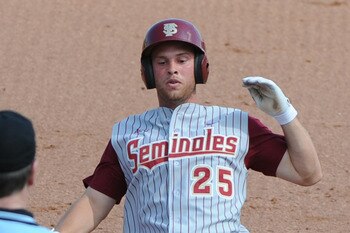 CLEARWATER, FL - FEBRUARY 24:  Outfielder Mike McGee #25 of  the Florida State Seminoles slides into third base against the Philadelphia Phillies February 24, 2011 at Bright House Field in Clearwater, Florida.  (Photo by Al Messerschmidt/Getty Images)