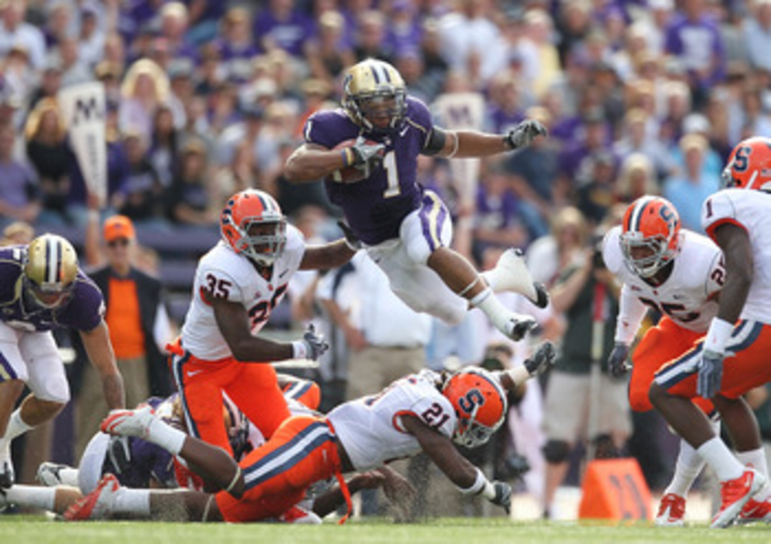 SEATTLE - SEPTEMBER 11:  Running back Chris Polk #1 of the Washington Huskies rushes against Michael Holmes #35 of the Syracuse Orange on September 11, 2010 at Husky Stadium in Seattle, Washington. (Photo by Otto Greule Jr/Getty Images)