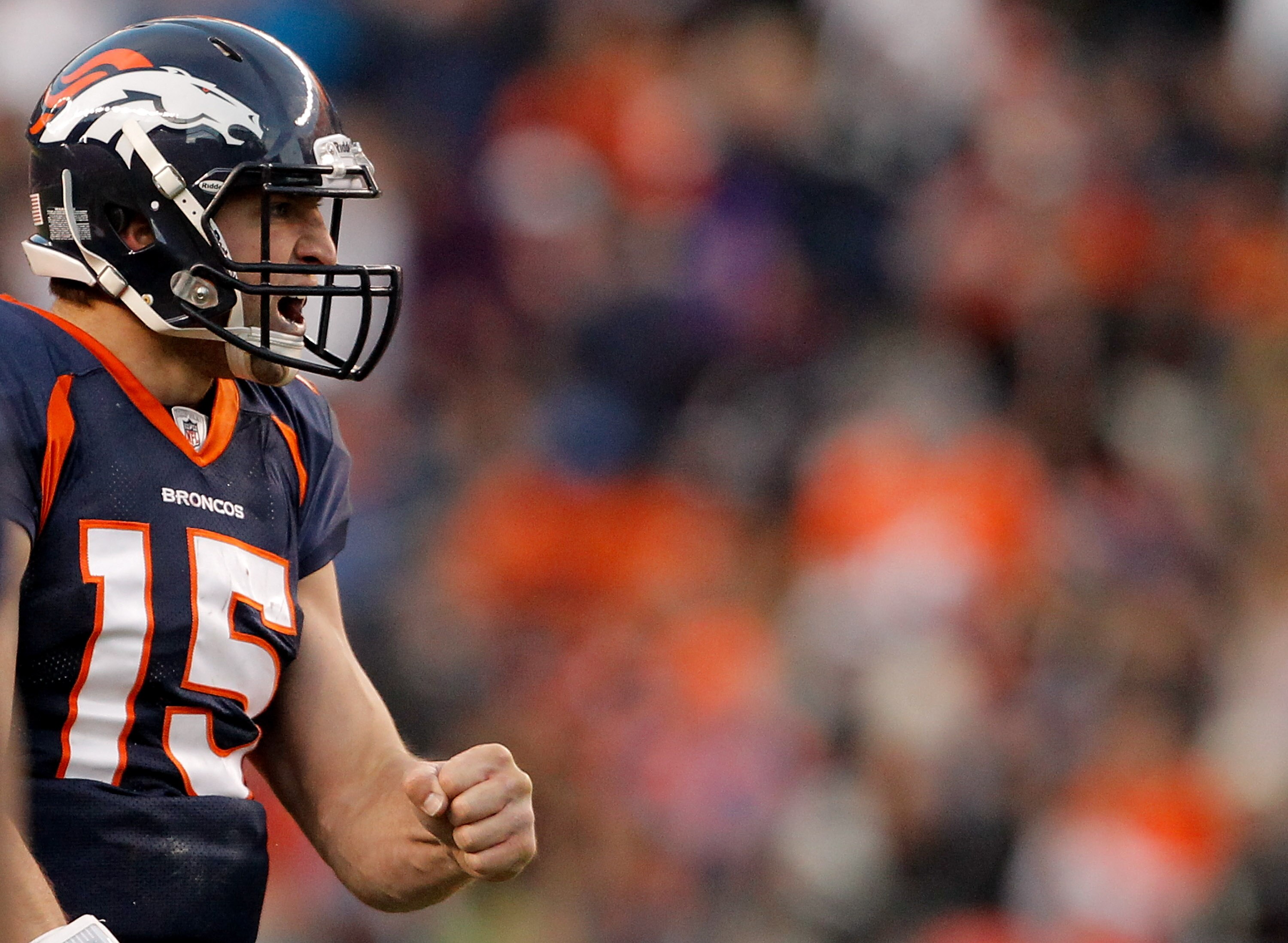 DENVER, CO - JANUARY 2:  Quarterback Tim Tebow #15 of the Denver Broncos celebrates a first down during the third quarter as running back Correll Buckhalter #28 walks back to the huddle against the San Diego Chargers at INVESCO Field at Mile High on Janua