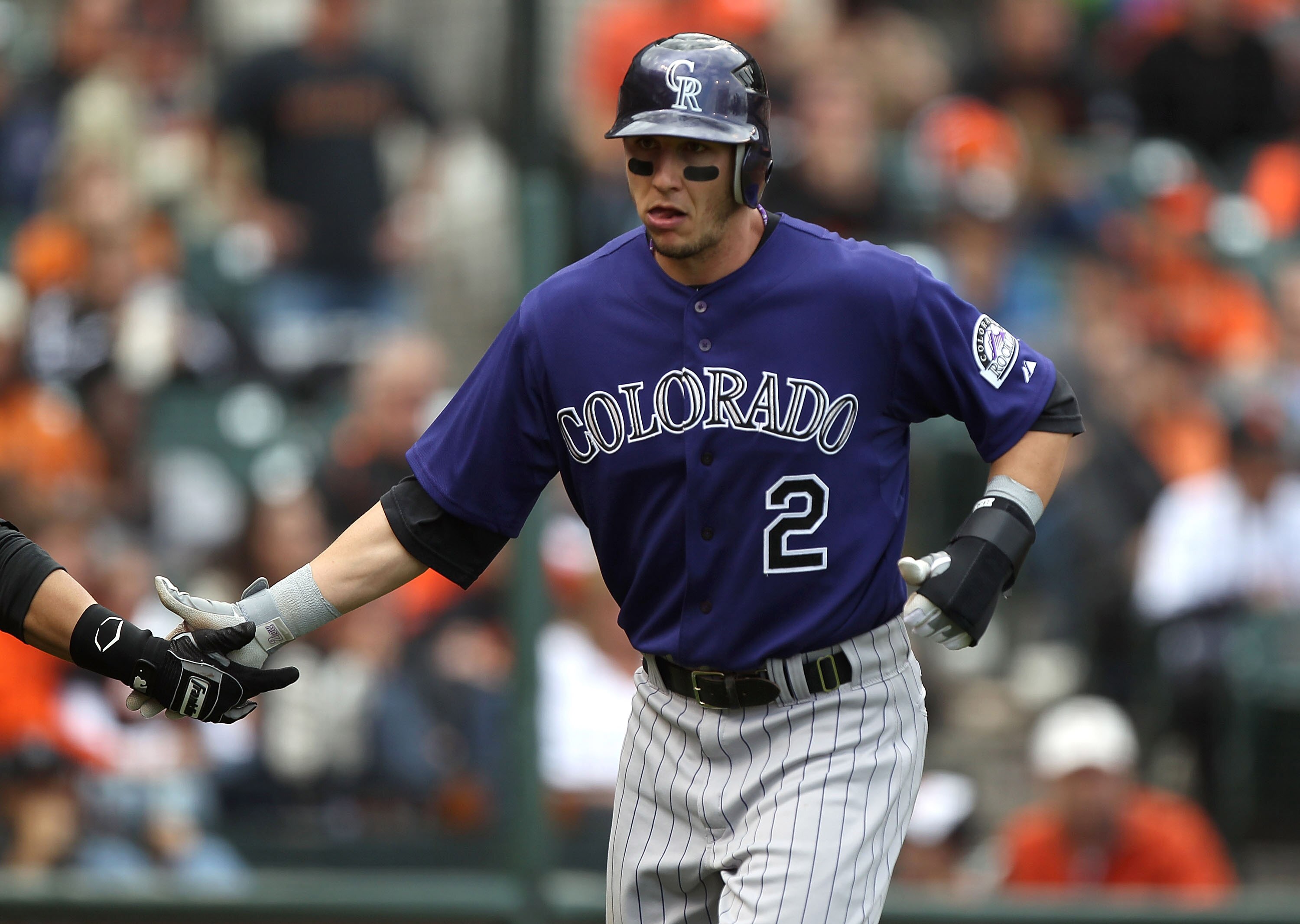 SAN FRANCISCO, CA - JUNE 04:  Troy Tulowitzki #2 of the Colorado Rockies celebrates after scoring in the fifth inning against the San Francisco Giants during an MLB game at AT&T Park on June 4, 2011 in San Francisco, California.  (Photo by Jed Jacobsohn/G