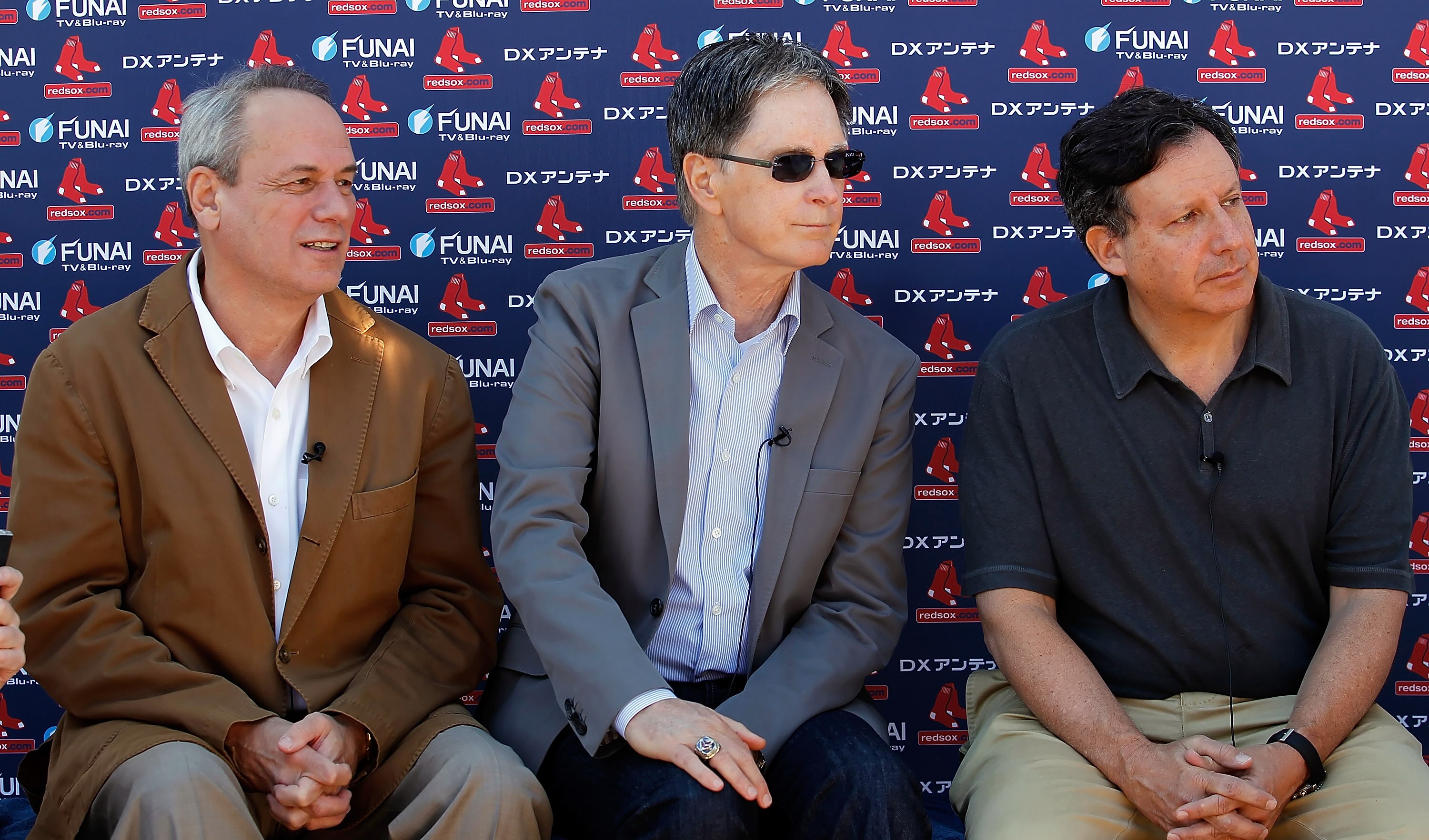 FORT MYERS, FL - FEBRUARY 19:  (L-R) President/CEO Larry Lucchino, Principal Owner John Henry and Chairman Tom Werner of the Boston Red Sox talk with the media during a Spring Training Workout Session at the Red Sox Player Development Complex on February