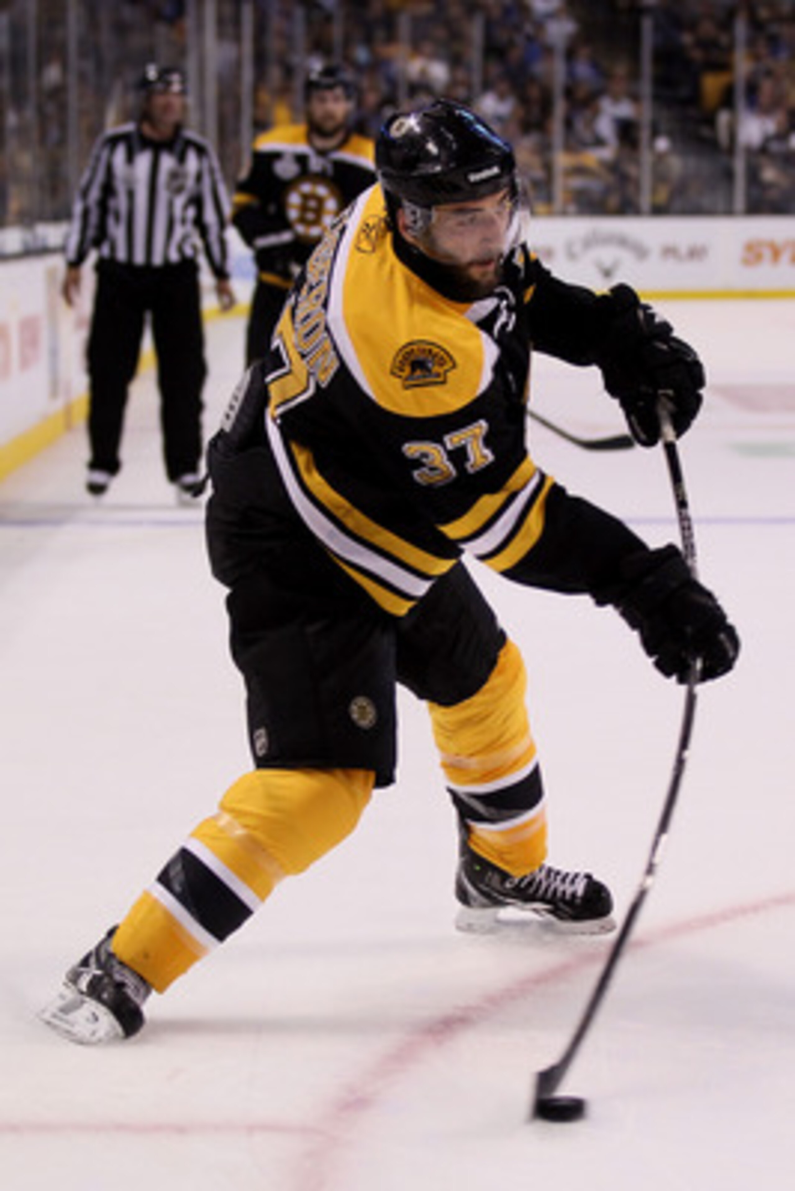 BOSTON, MA - JUNE 06:  Patrice Bergeron #37 of the Boston Bruins skates against the Vancouver Canucks during Game Three of the 2011 NHL Stanley Cup Final at TD Garden on June 6, 2011 in Boston, Massachusetts.  (Photo by Elsa/Getty Images)