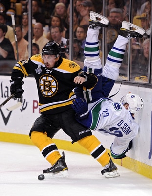 BOSTON, MA - JUNE 08:  Brad Marchand #63 of the Boston Bruins dodges Daniel Sedin #22 of the Vancouver Canucks during Game Four of the 2011 NHL Stanley Cup Final at TD Garden on June 8, 2011 in Boston, Massachusetts.  (Photo by Harry How/Getty Images)