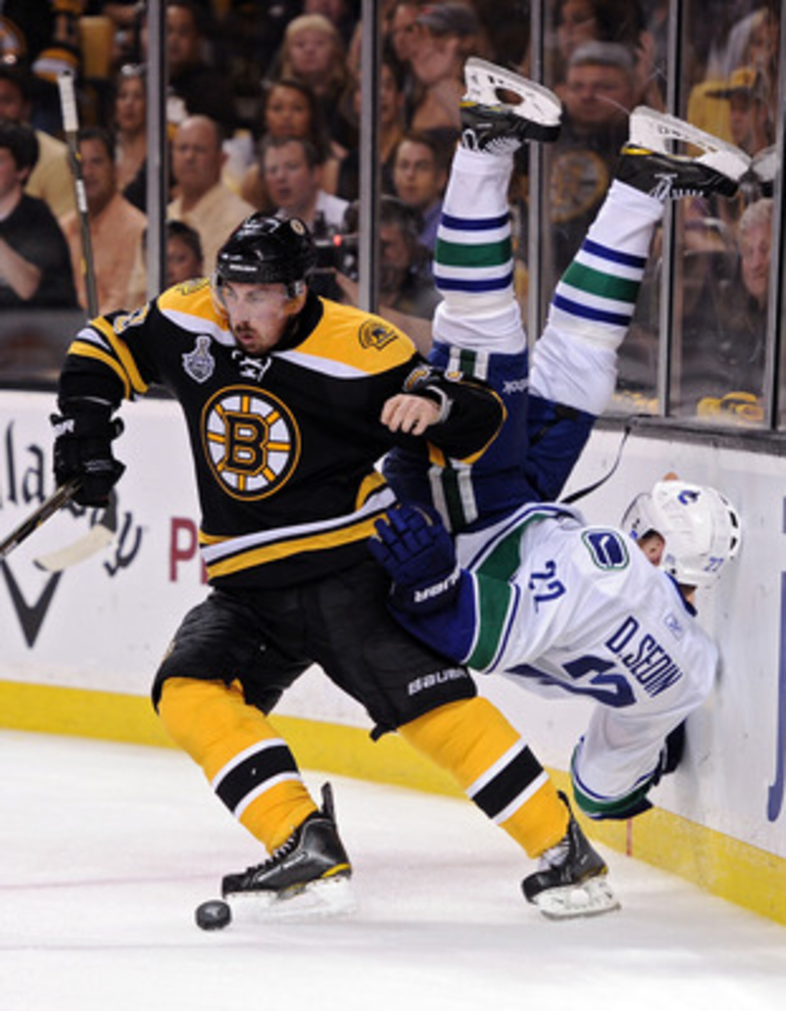 BOSTON, MA - JUNE 08:  Brad Marchand #63 of the Boston Bruins dodges Daniel Sedin #22 of the Vancouver Canucks during Game Four of the 2011 NHL Stanley Cup Final at TD Garden on June 8, 2011 in Boston, Massachusetts.  (Photo by Harry How/Getty Images)