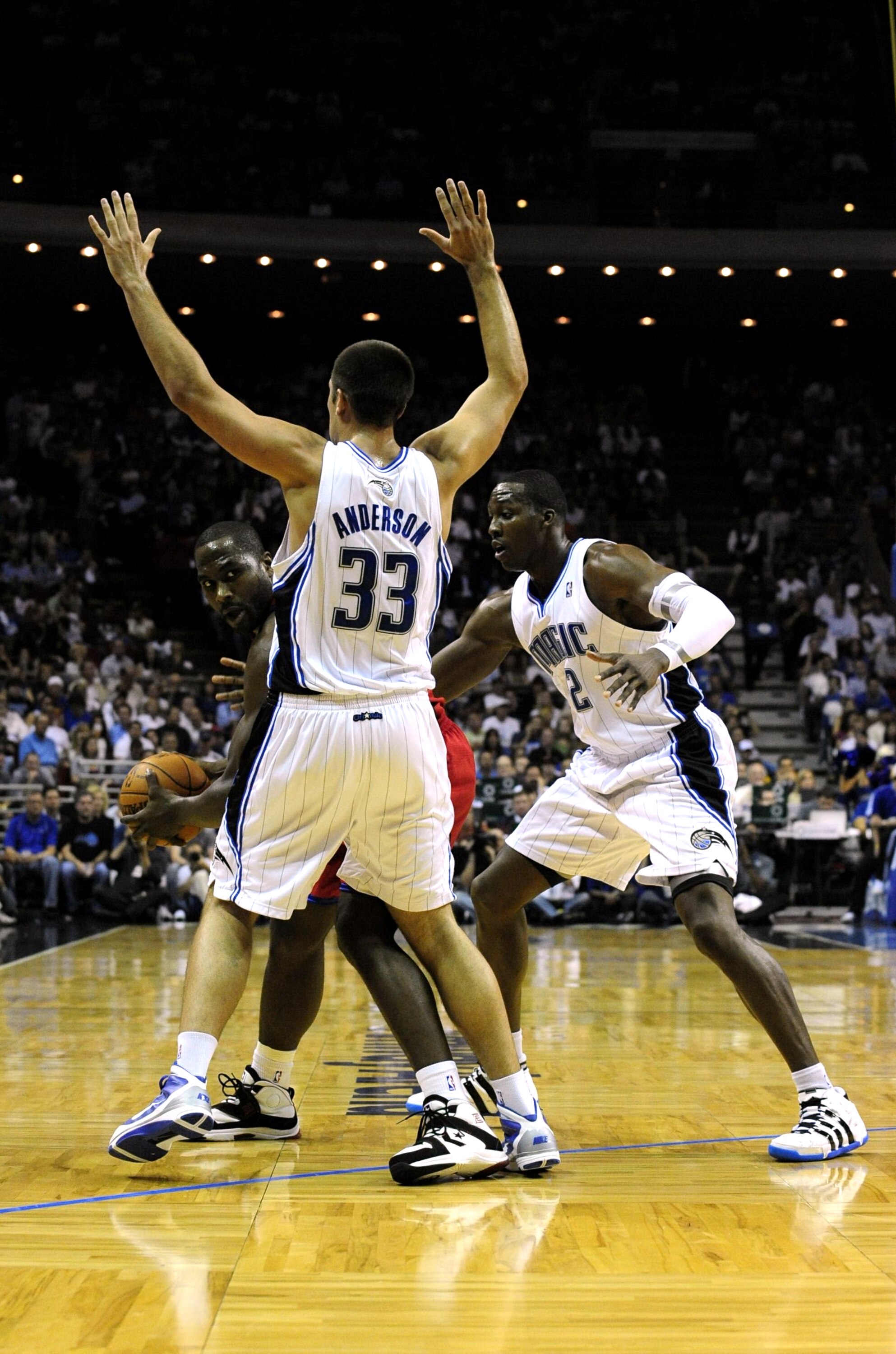 ORLANDO, FL - OCTOBER 28:  Elton Brand #42 of the Philadelphia 76ers looks for an open pass around Ryan Anderson #33 and Mickael Pietrus #20 of the Orlando Magic during the game on October 28, 2009 at Amway Arena in Orlando, Florida.  NOTE TO USER: User e