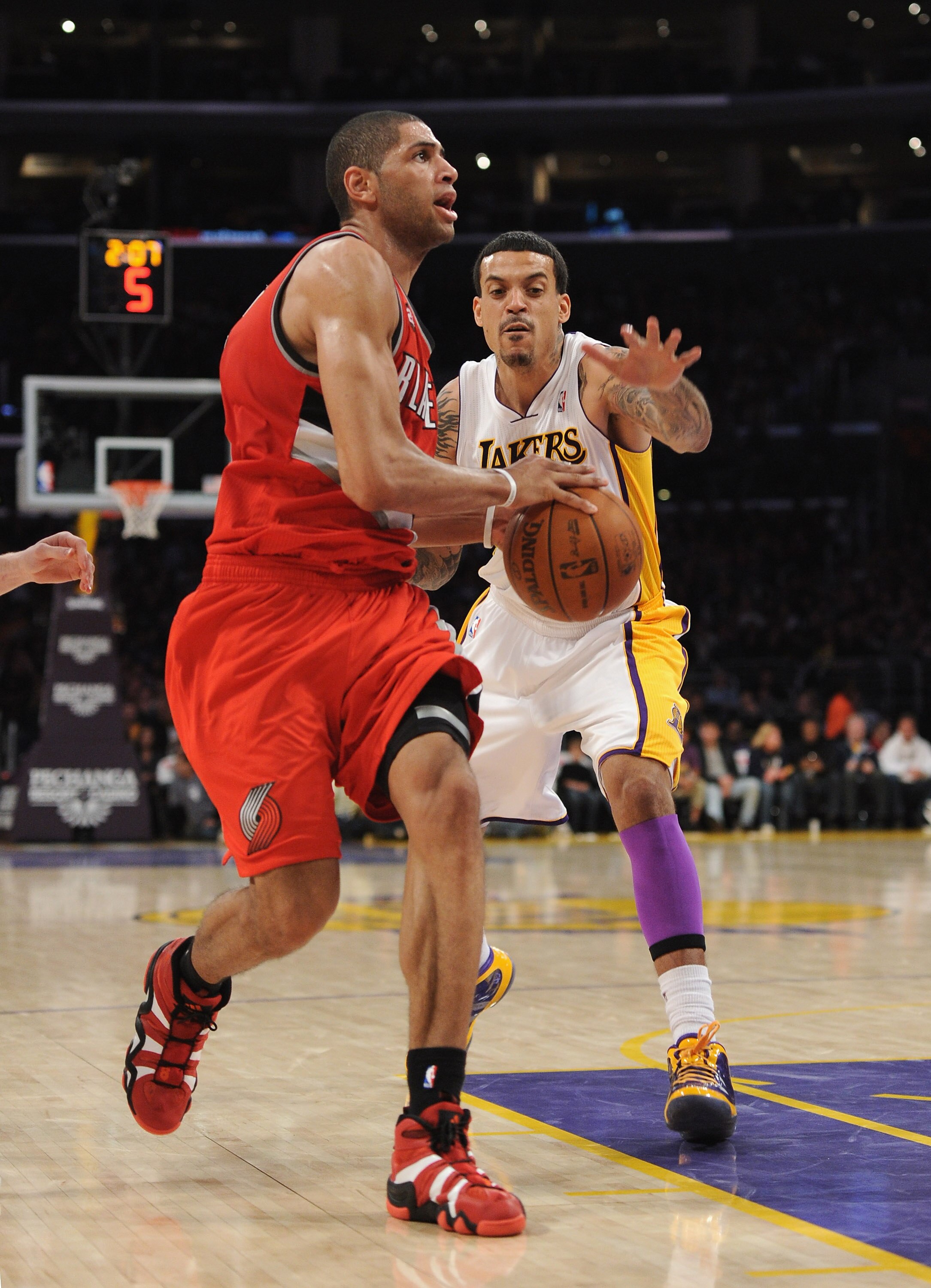 LOS ANGELES, CA - MARCH 20:  Nicolas Batum #88 of the Portland Trail Blazers is chased by Matt Barnes #9 of the Los Angeles Lakers at the Staples Center on March 20, 2011 in Los Angeles, California.  NOTE TO USER: User expressly acknowledges and agrees th