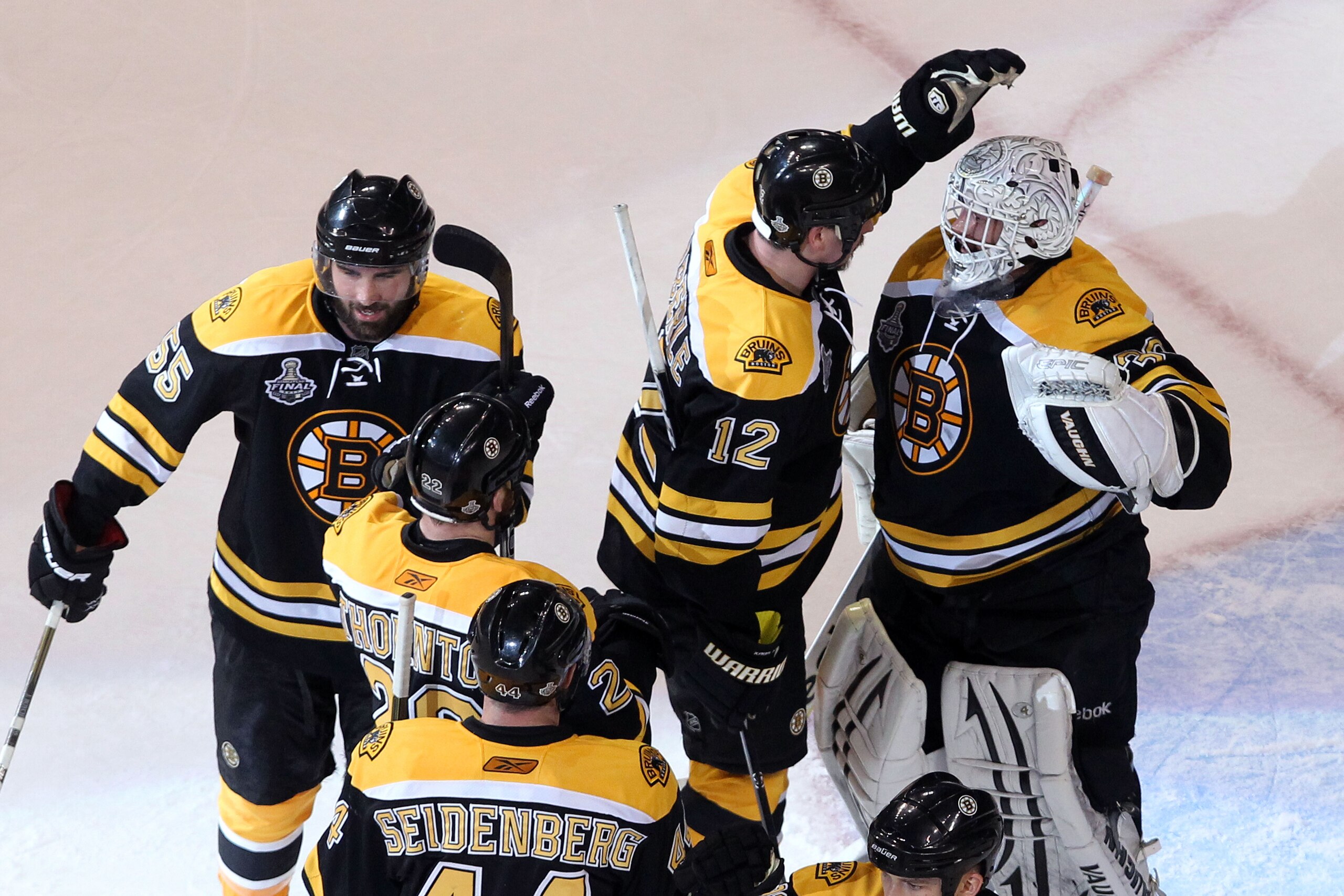 BOSTON, MA - JUNE 08:  Tim Thomas #30 of the Boston Bruins celebrates with his teammates Dennis Seidenberg #44, Johnny Boychuk #55 and Tomas Kaberle #12 after defeating the Vancouver Canucks in Game Four of the 2011 NHL Stanley Cup Final at TD Garden on J