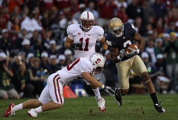 SOUTH BEND, IN - SEPTEMBER 25: Taylor Skaufel #40 of the Stanford Cardinal moves to tackle Michael Floyd #3 of the Notre Dame Fighting Irish as Shayne Skov #11 closes in at Notre Dame Stadium on September 25, 2010 in South Bend, Indiana. Stanford defeated