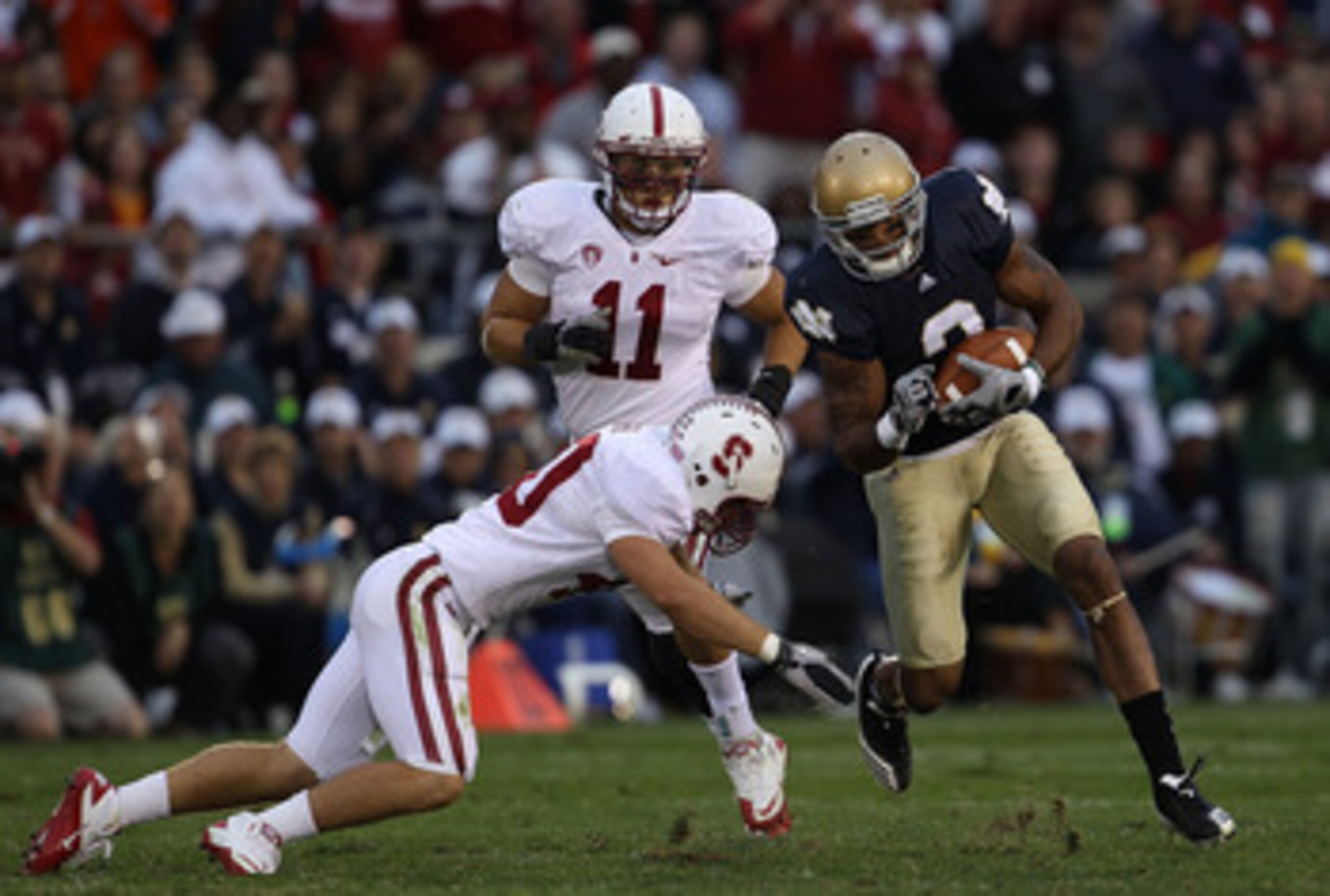 SOUTH BEND, IN - SEPTEMBER 25: Taylor Skaufel #40 of the Stanford Cardinal moves to tackle Michael Floyd #3 of the Notre Dame Fighting Irish as Shayne Skov #11 closes in at Notre Dame Stadium on September 25, 2010 in South Bend, Indiana. Stanford defeated
