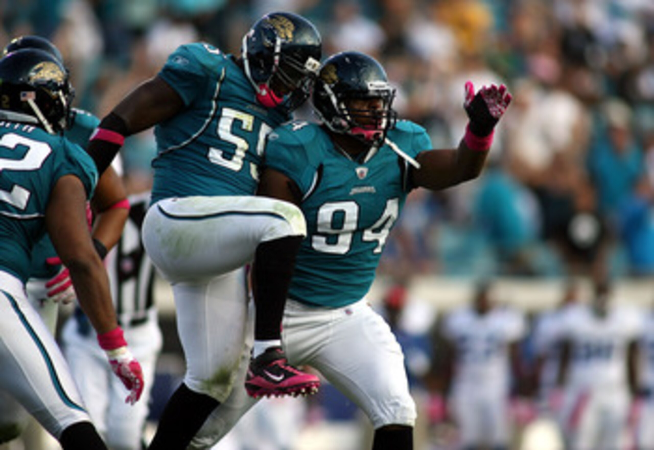 JACKSONVILLE, FL - OCTOBER 03:  Lineman Jeremy Mincey #94 of the Jacksonville Jaguars celebrates with Kirk Morreson after sacking Quarterback Peyton Manning #18 of the Indianapolis Colts at EverBank Field on October 3, 2010 in Jacksonville, Florida.  (Pho