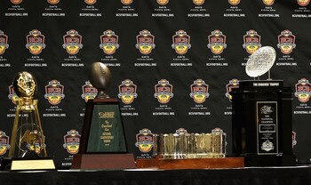 SCOTTSDALE, AZ - JANUARY 11:  Head coach Gene Chizik of the Auburn Tigers sits with the (L-R) Associated Press, Football Writers of America, MacArthur Bowl and the Coaches trophys during a press conference for the Tostitos BCS National Championship Game a