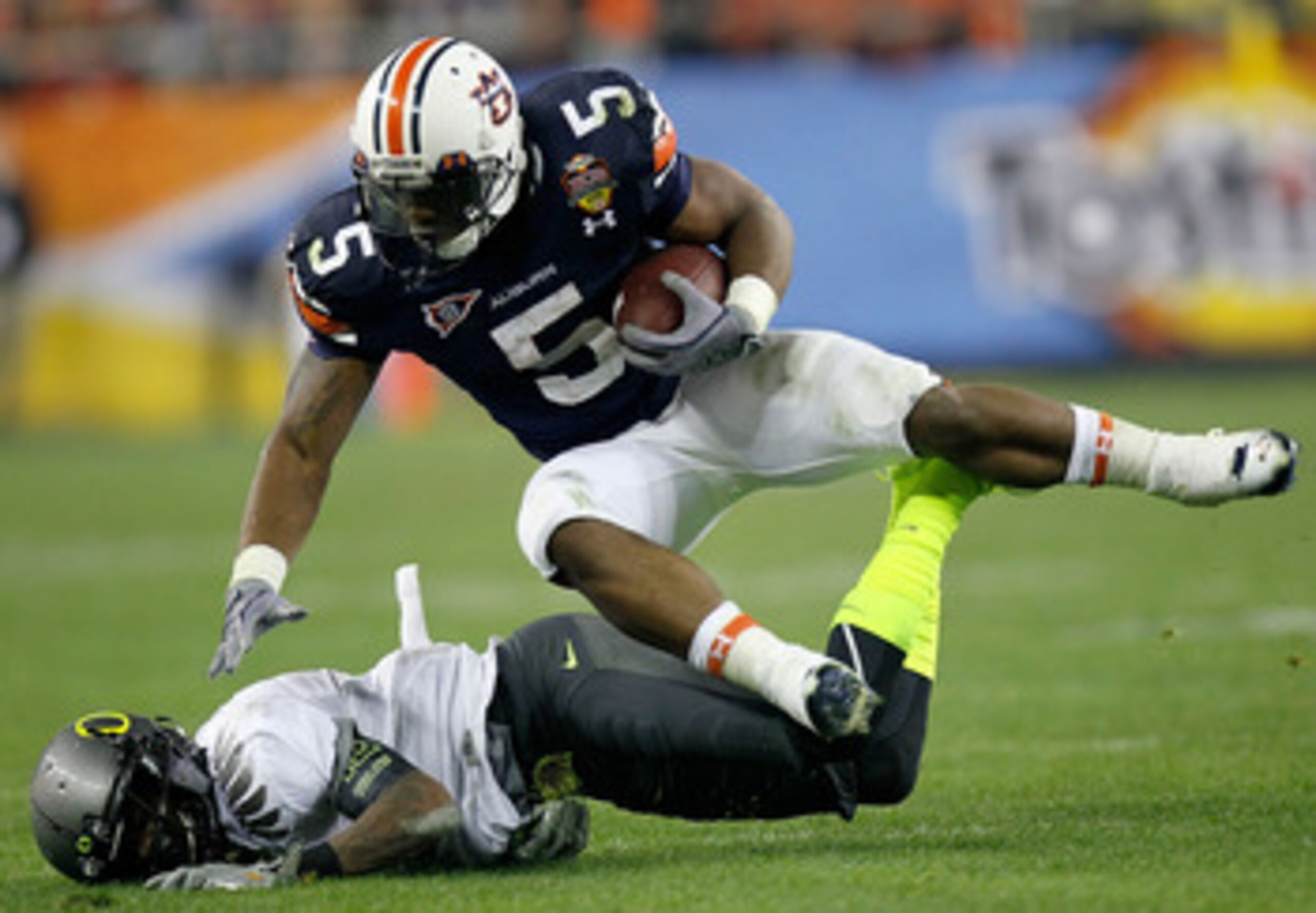 GLENDALE, AZ - JANUARY 10:  Michael Dyer #5 of the Auburn Tigers is tackled by Tevin Cheever #12 of the Oregon Ducks in the third quarter of the Tostitos BCS National Championship Game at University of Phoenix Stadium on January 10, 2011 in Glendale, Ariz
