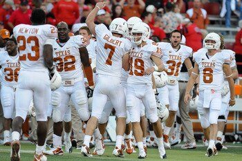 LINCOLN, NE - OCTOBER 16: Quarterback Garrett Gilbert #7 of the Texas Longhorns runs toward his teammates ofter the final of their game against the Nebraska Cornhuskers at Memorial Stadium on October 16, 2010 in Lincoln, Nebraska. Texas Defeated Nebraska