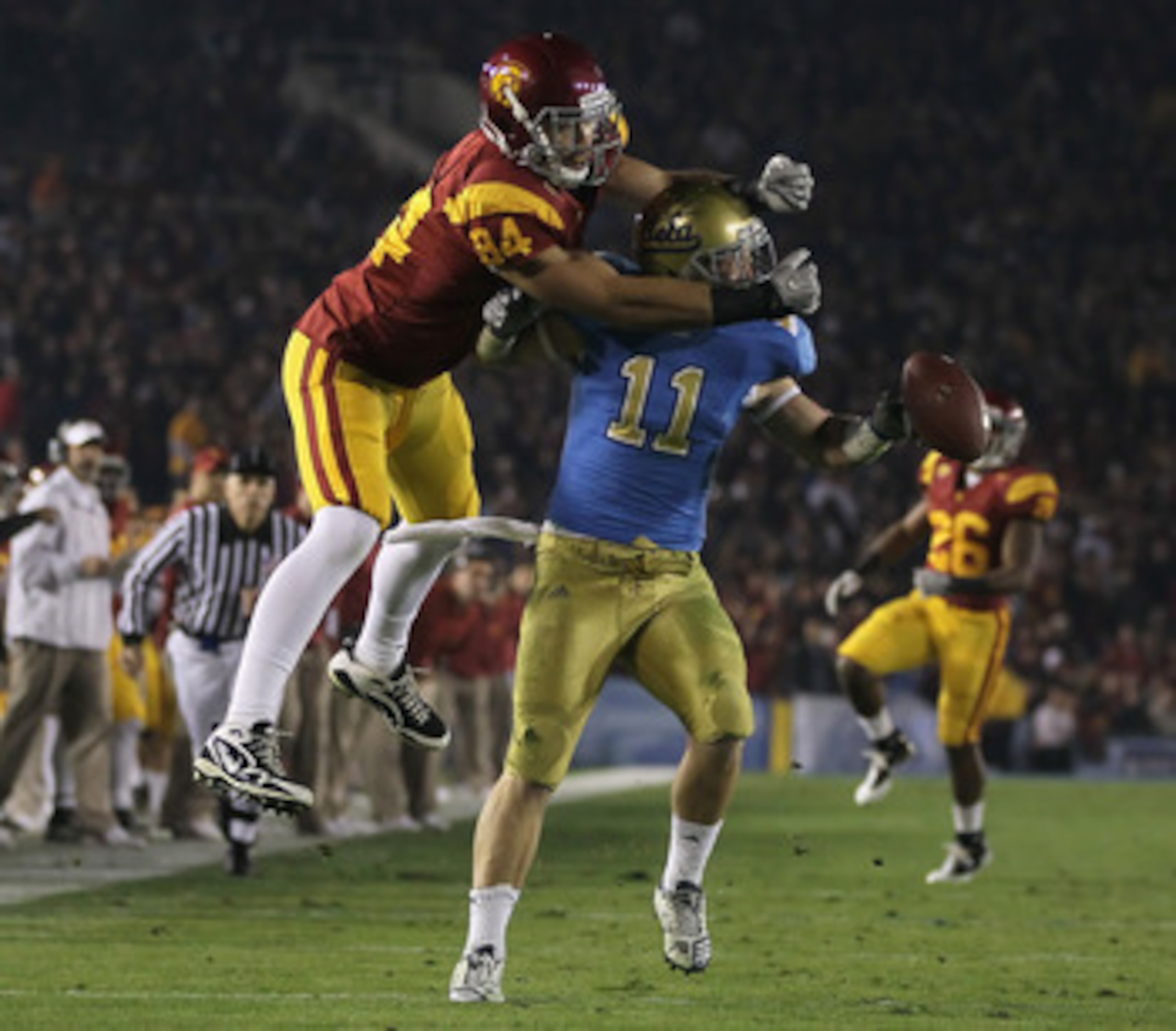 PASADENA, CA - DECEMBER 04:  Sean Westgate #11 of the UCLA Bruins breaks up a pass intended for Jordan Cameron #84 of the USC Trojans during the first half at the Rose Bowl on December 4, 2010 in Pasadena, California. USC defeated UCLA 28-14.  (Photo by J