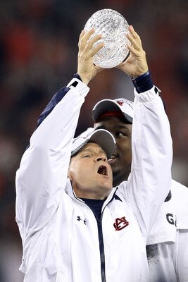GLENDALE, AZ - JANUARY 10:  Head coach Gene Chizik of the Auburn Tigers celebrates the Tigers 22-19 victory as he holds up the Coaches Trophy after defeating the Oregon Ducks during the Tostitos BCS National Championship Game at University of Phoenix Stad