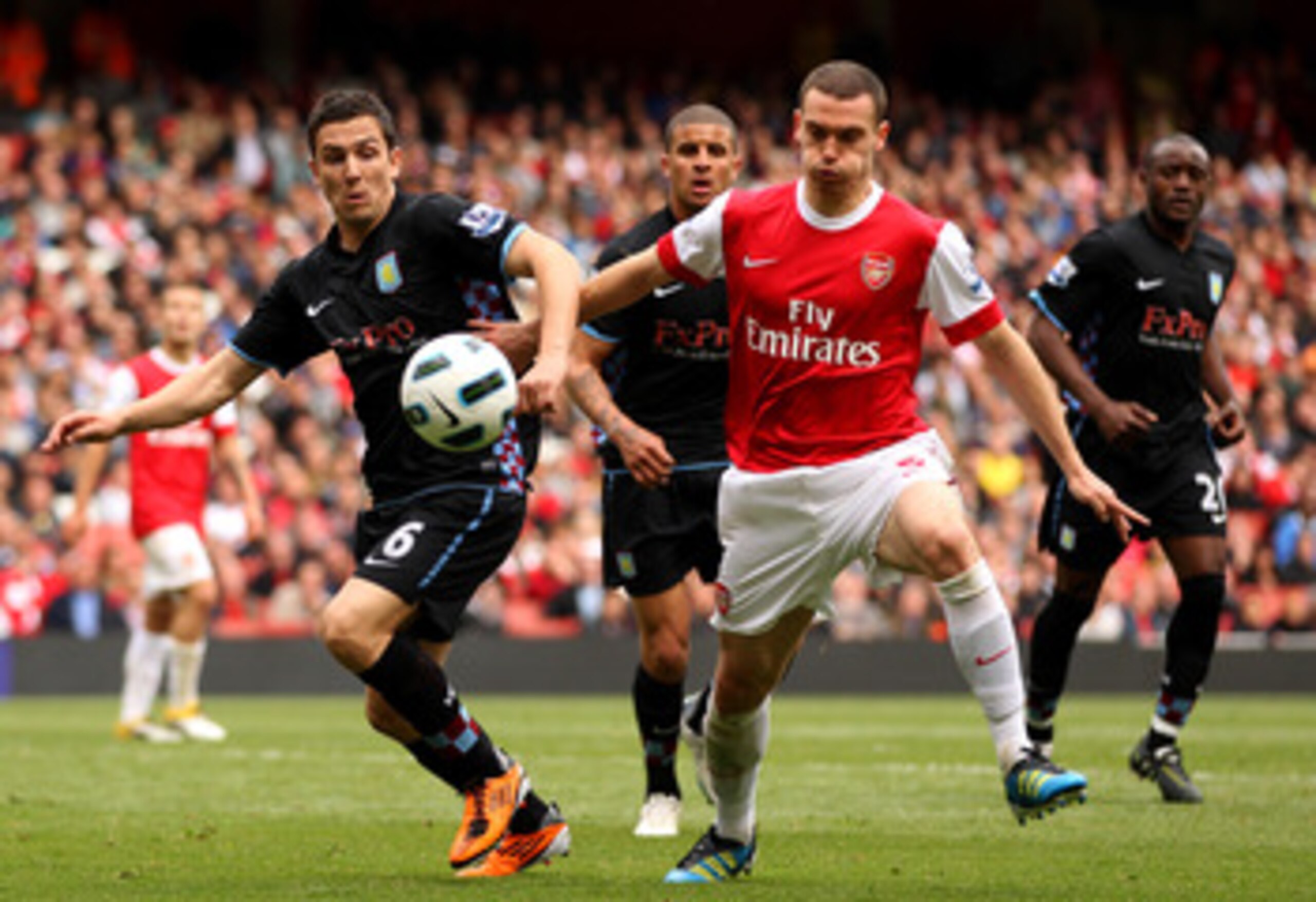 LONDON, ENGLAND - MAY 15:  Thomas Vermaelen (R) of Arsenal collides with Stewart Downing of Aston Villa during the Barclays Premier League match between Arsenal and Aston Villa at the Emirates Stadium on May 15, 2011 in London, England.  (Photo by Richard
