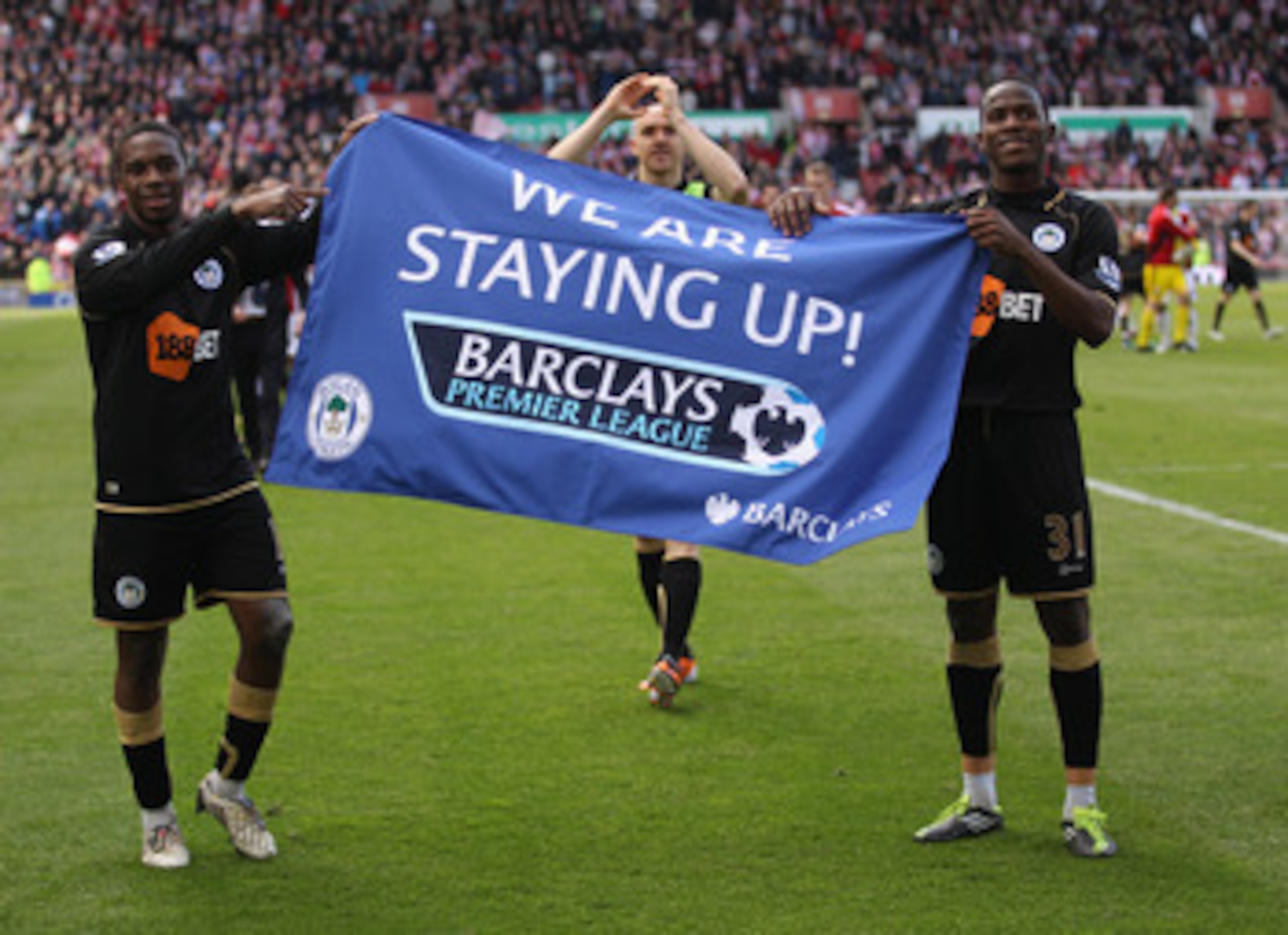 STOKE ON TRENT, ENGLAND - MAY 22:  Charles N'Zogbia  and Maynor Figueroa of Wigan  celebrate staying up during the Barclays Premier League match between Stoke City and Wigan Athletic at Britannia Stadium on May 22, 2011 in Stoke on Trent, England.  (Photo