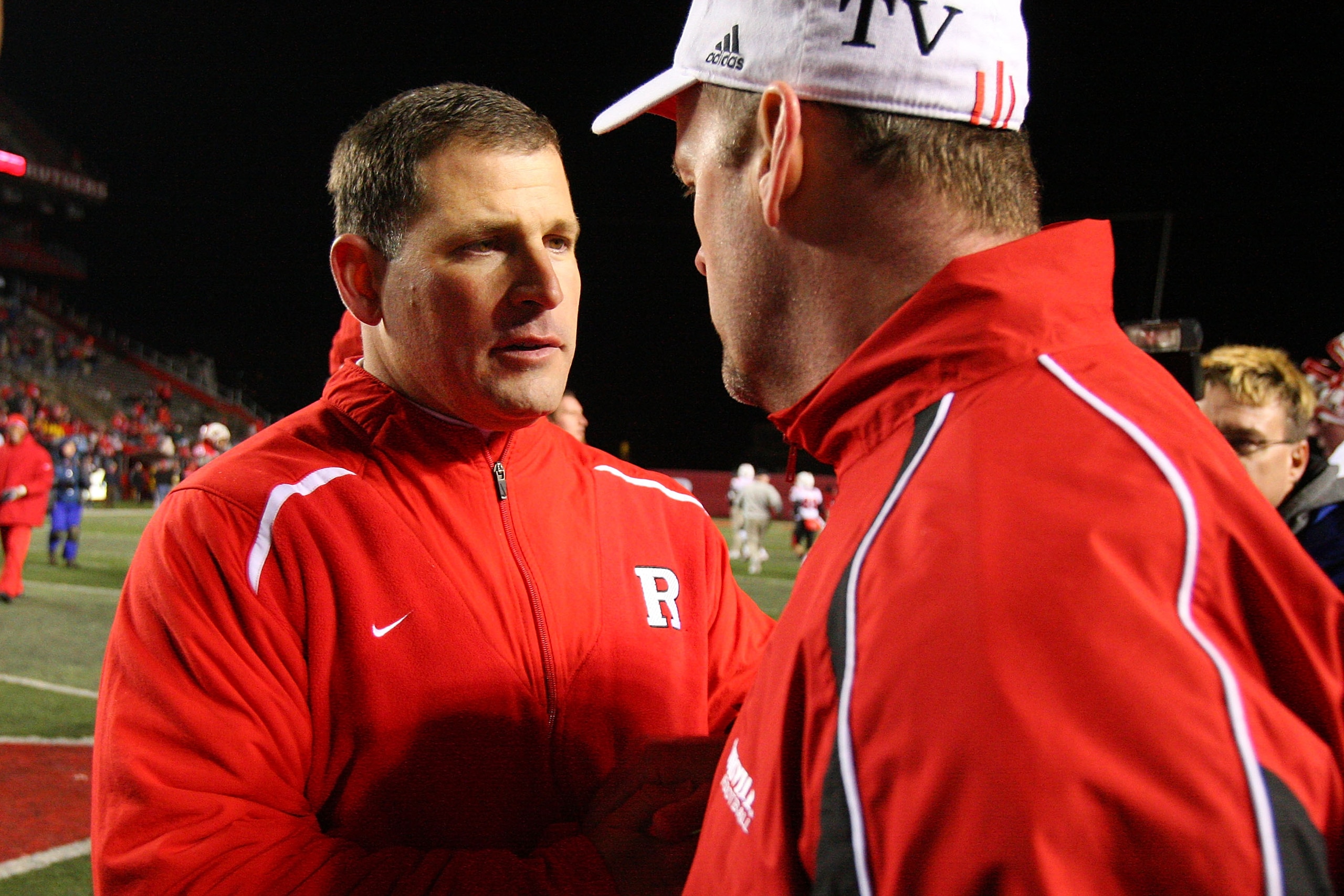 PISCATAWAY, NJ - DECEMBER 04:  (L-R) Greg Schiano head coach of the Rutgers Scarlet Knights shakes hands with Steve Kragthorpe head coach of the Louisville Cardinals after the game at Rutgers Stadium on December 4, 2008 in Piscataway, New Jersey.  (Photo