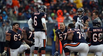 CHICAGO, IL - JANUARY 16:  Quarterback Jay Cutler #6 of the Chicago Bears talks with his offense as Marcus Trufant #23 of the Seattle Seahawks is injured on the field in the second half against the Seattle Seahawks in the 2011 NFC divisional playoff game 
