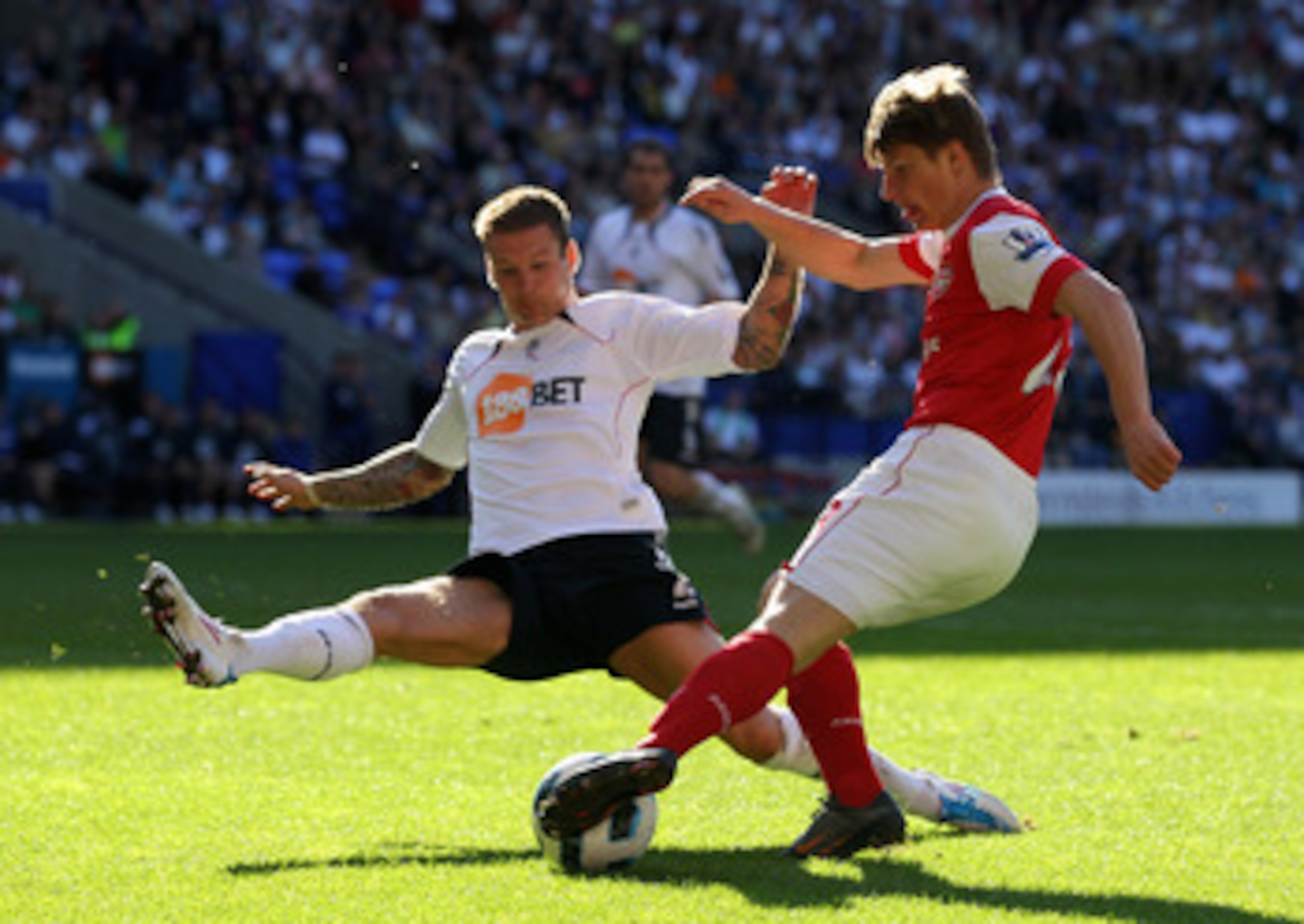 BOLTON, ENGLAND - APRIL 24:  Gretar Steinsson of Bolton Wanderers competes with Andrey Arshavin of Arsenal during the Barclays Premier League match between Bolton Wanderers and Arsenal at the Reebok Stadium on April 24, 2011 in Bolton, England.  (Photo by