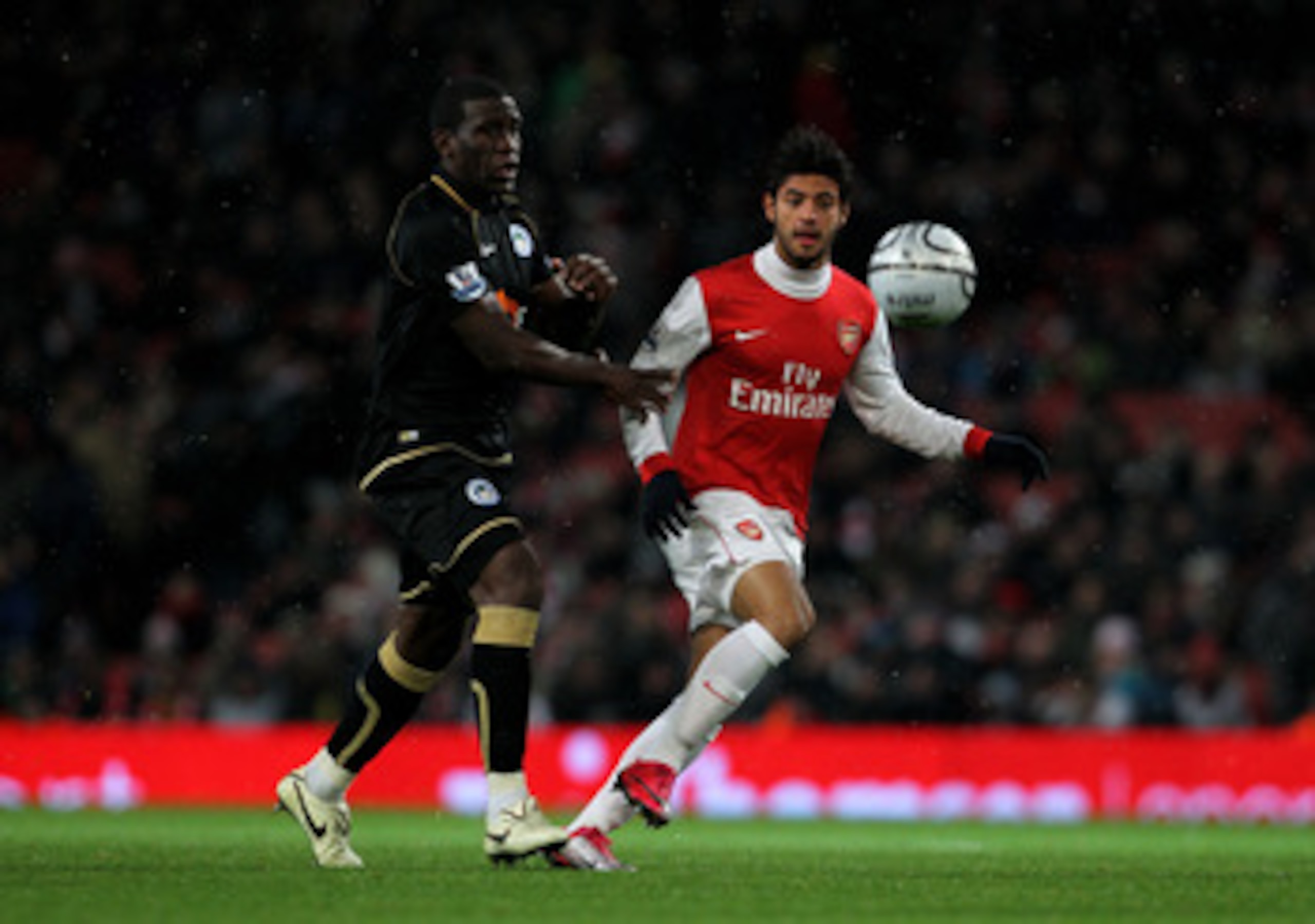 LONDON, ENGLAND - NOVEMBER 30: Hendry Thomas (L) of Wigan in action against Carlos Vela of Arsenal during the Carling Cup quarter final match between Arsenal and Wigan Athletic at the Emirates Stadium on November 30, 2010 in London, England.  (Photo by Cl