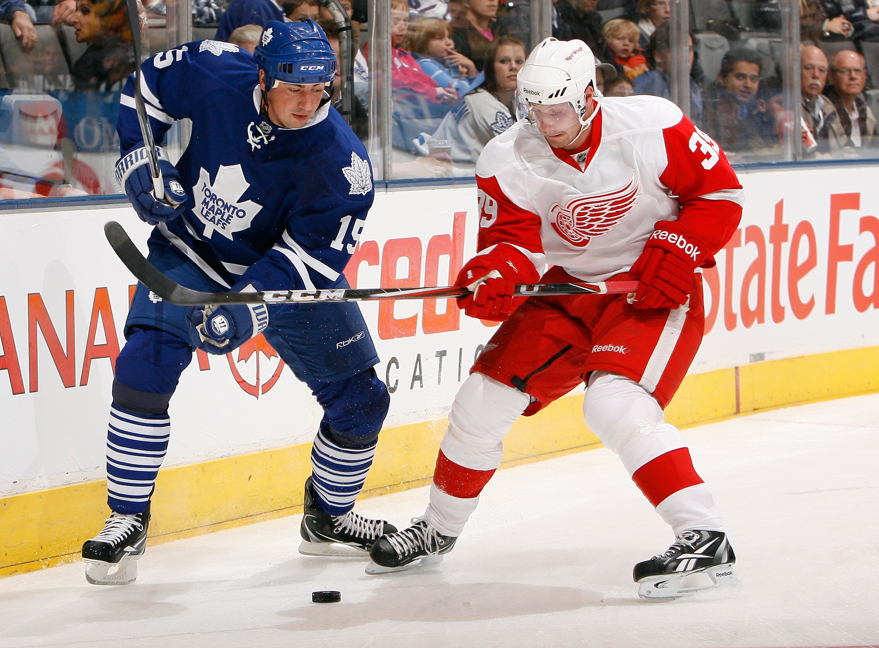 TORONTO - OCTOBER 2: Tomas Kaberle #15  of the Toronto Maple Leafs battles for the puck with Jan Mursak #39 of the Detroit Red Wings during a preseason NHL game at the Air Canada Centre October 2, 2010 in Toronto, Ontario, Canada. (Photo by Abelimages/Get