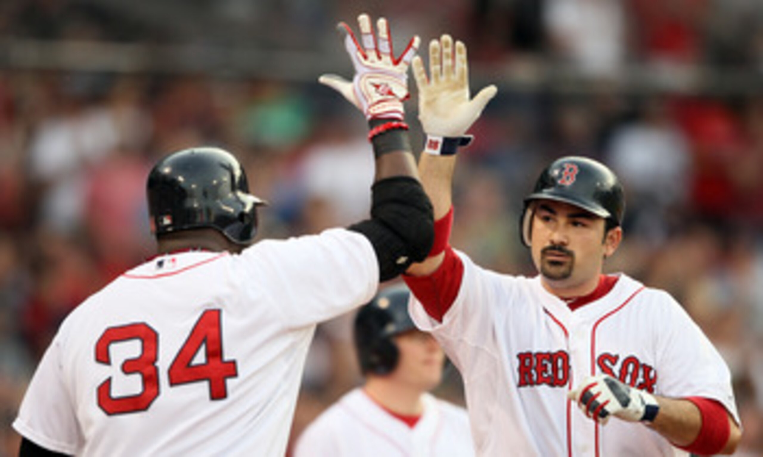 BOSTON, MA - MAY 30: Adrian Gonzalez #28 of the Boston Red Sox is congratulated by teammate David Ortiz #34 after Gonzalez hits a a solo home run in the first inning against the Chicago White Sox on May 30, 2011 at Fenway Park in Boston, Massachusetts. BOSTON, MA - MAY 30: Adrian Gonzalez #28 of the Boston Red Sox is congratulated by teammate David Ortiz #34 after Gonzalez hits a a solo home run in the first inning against the Chicago White Sox on May 30, 2011 at Fenway Park in Boston, Massachusetts.