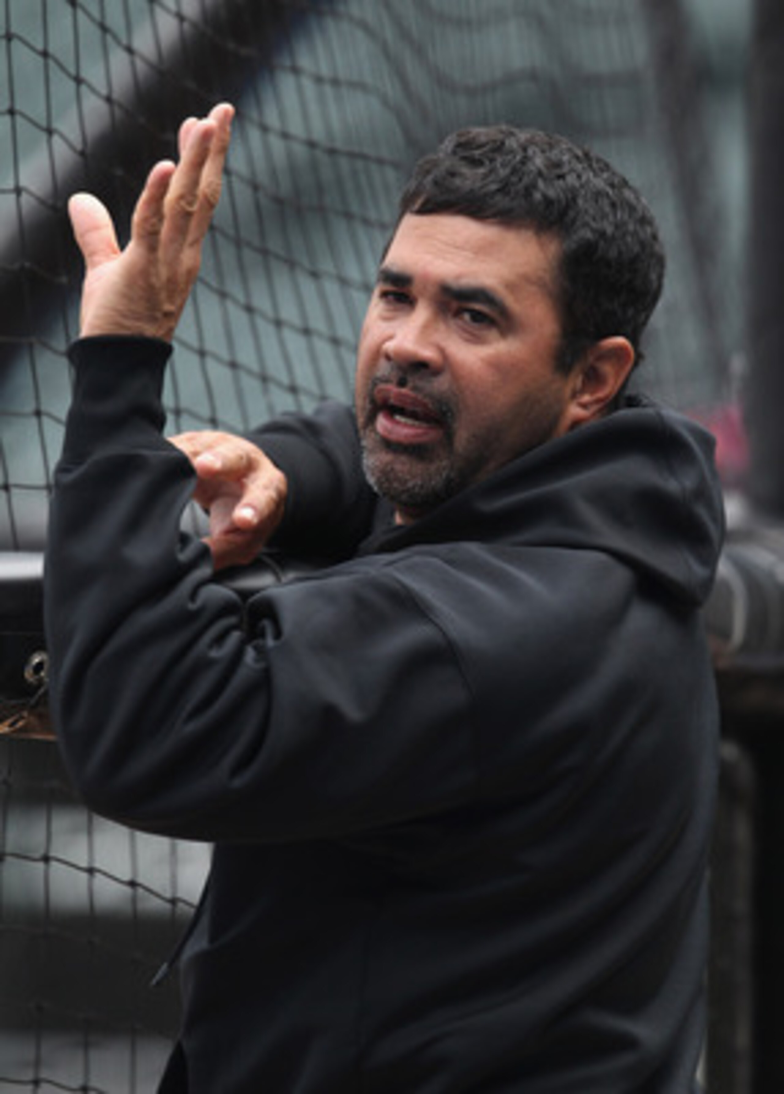 CHICAGO, IL - JUNE 09:  Manager Ozzie Guillen #13 of the Chicago White Sox talks with a player during batting practice before a game against the Oakland Athletics at U.S. Cellular Field on June 9, 2011 in Chicago, Illinois.  (Photo by Jonathan Daniel/Gett