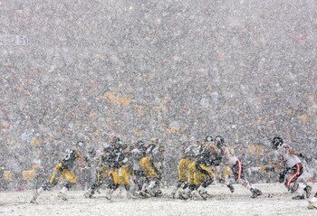 PITTSBURGH - DECEMBER 11:  Quarterback Ben Roethlisberger #7 of the Pittsburgh Steelers drops back to hand off the ball in the heavy snow during their game against the Chicago Bears on December 11, 2005 at Heinz Field in Pittsburgh, Pennsylvania. The Stee