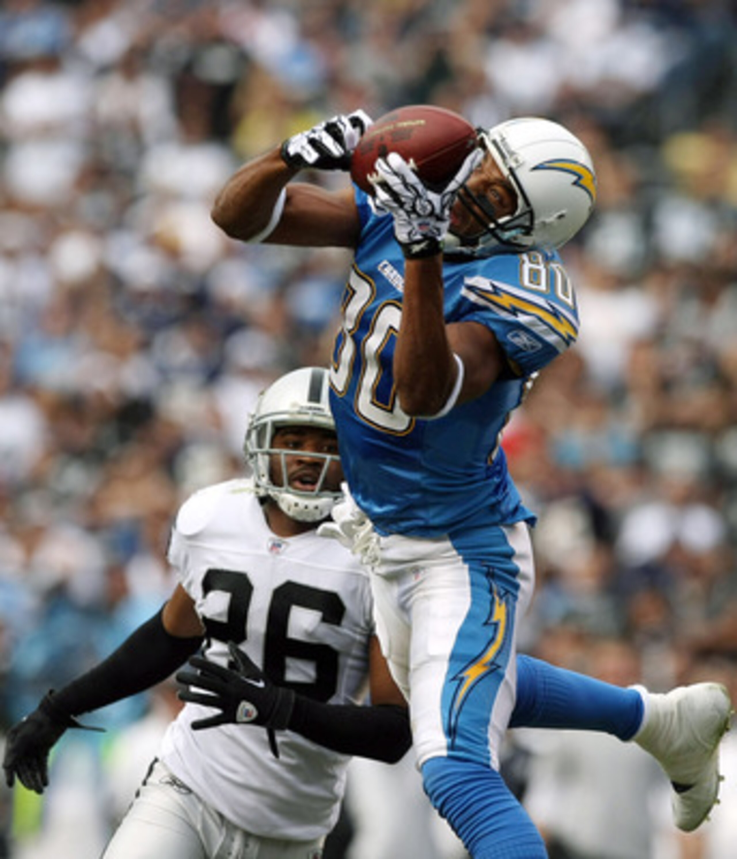 SAN DIEGO - DECEMBER 5:  Wide Receiver Malcom Floyd #80 of the San Diego Chargers goes up for a reception  against Cornerback Stanford Routt #26 of the Oakland Raiders during their NFL game at Qualcomm Stadium on December 5, 2010 in San Diego, California.